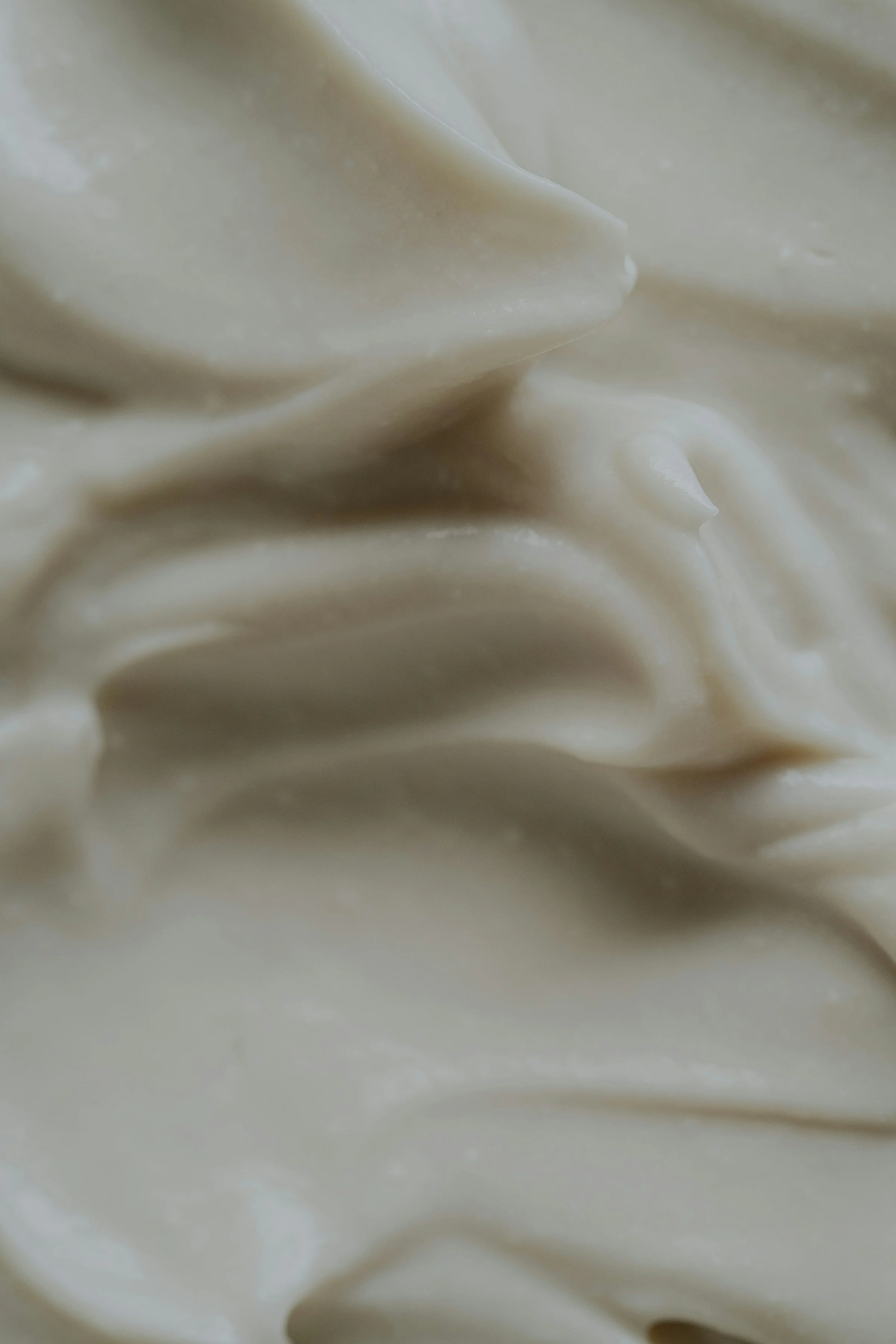 Close-up of a creamy, white substance with smooth, swirling textures.