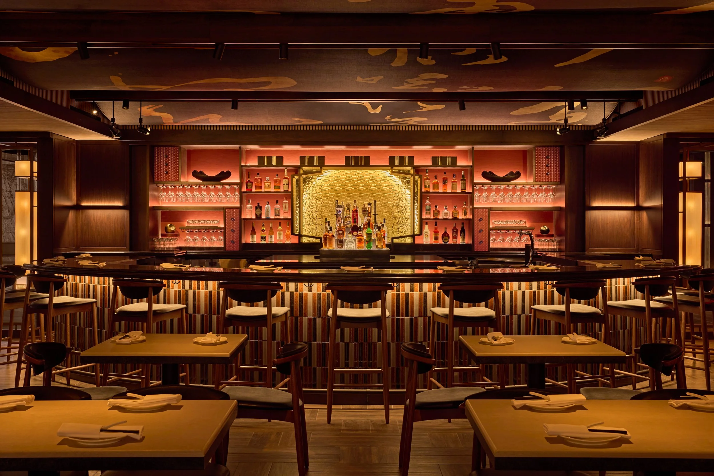 Din Tai Fung's dining room before service has started showcasing a lit up bar and set tables
