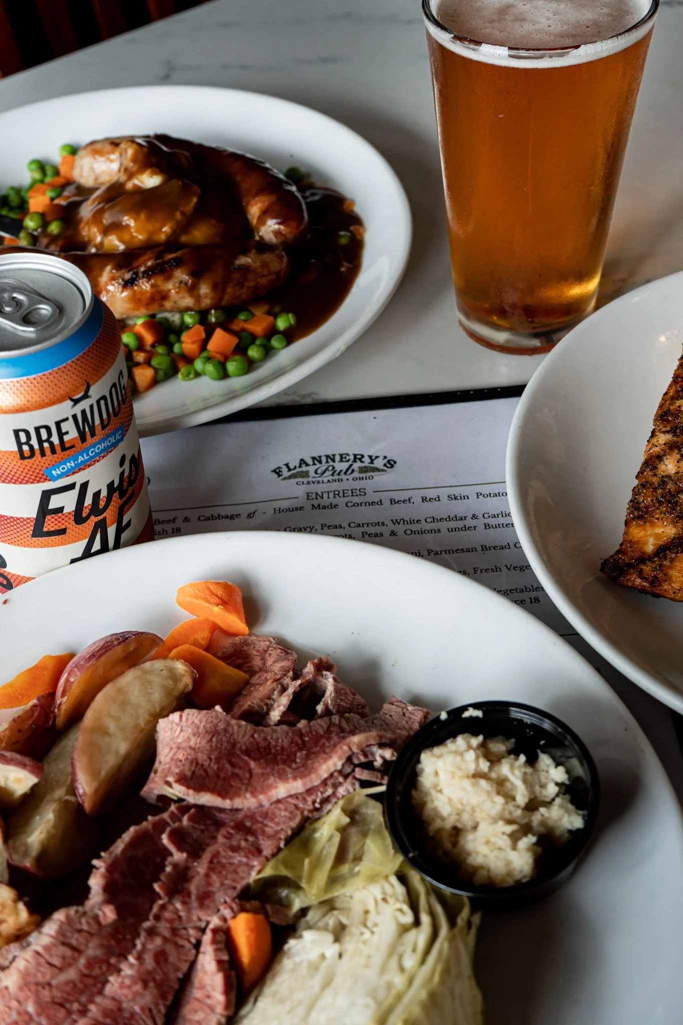 Bangers and mash, corned beef and cabbage, and BrewDog non-alcoholic beer served at Flannery's Pub in Downtown Cleveland