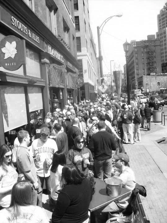 Crowd lined up outside Flannery's Pub before a Guardians home game near Progressive Field in Cleveland