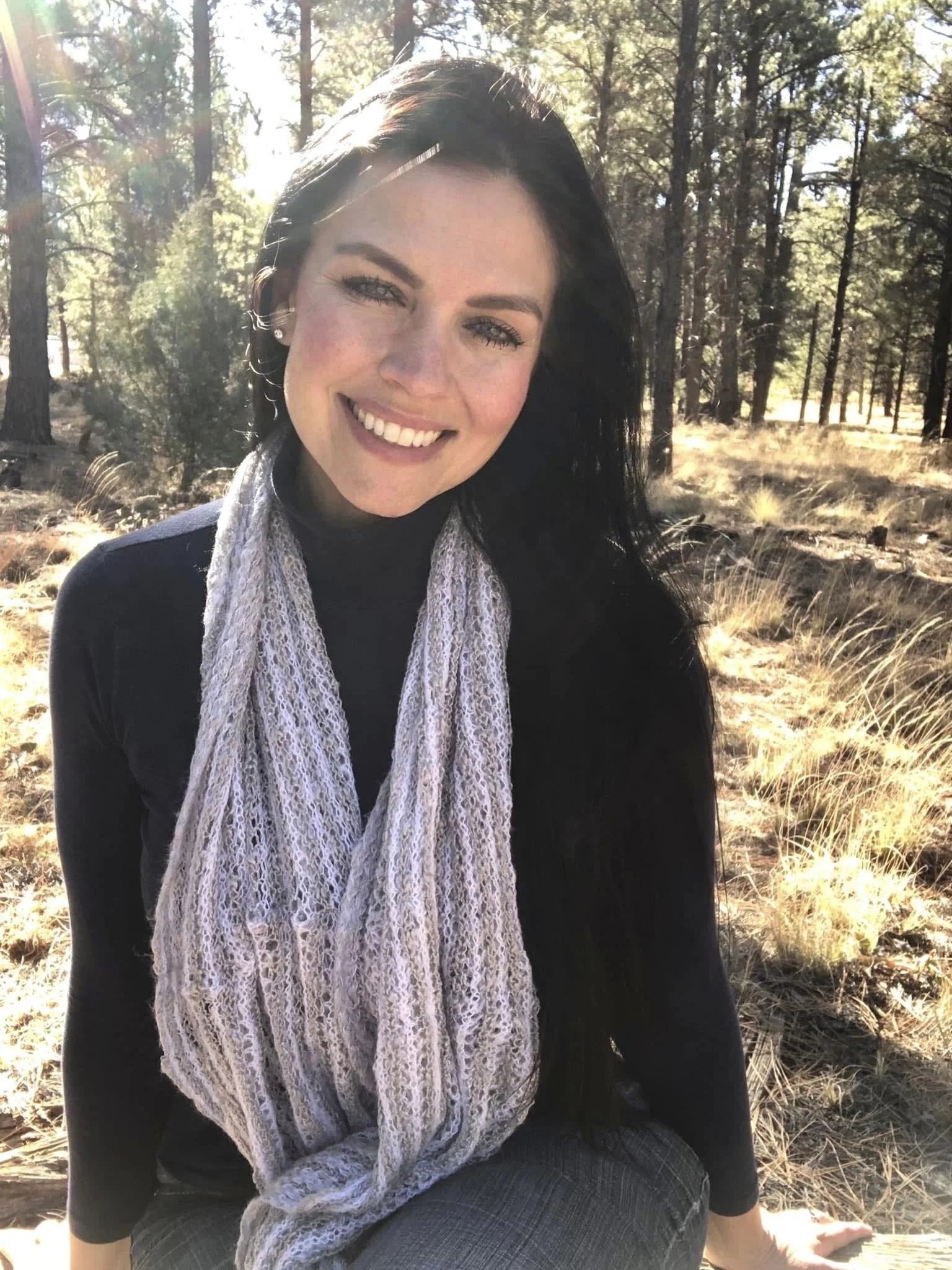 Autumn Jerumbo sitting in a ponderosa pine forest in Northern Arizona, reflecting on intentional living, personal growth, and self-discovery.