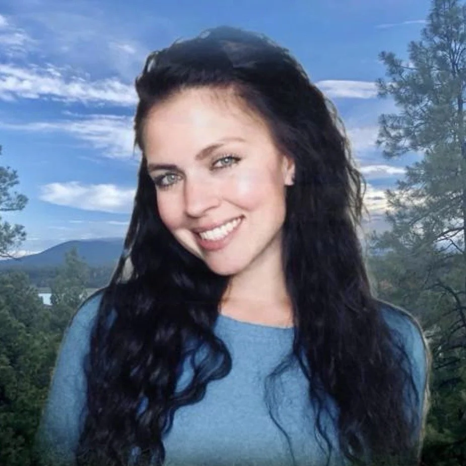 Autumn Jerumbo outdoors with mountains and a lake in the background, representing freedom, self-reliance, and a nomadic lifestyle.