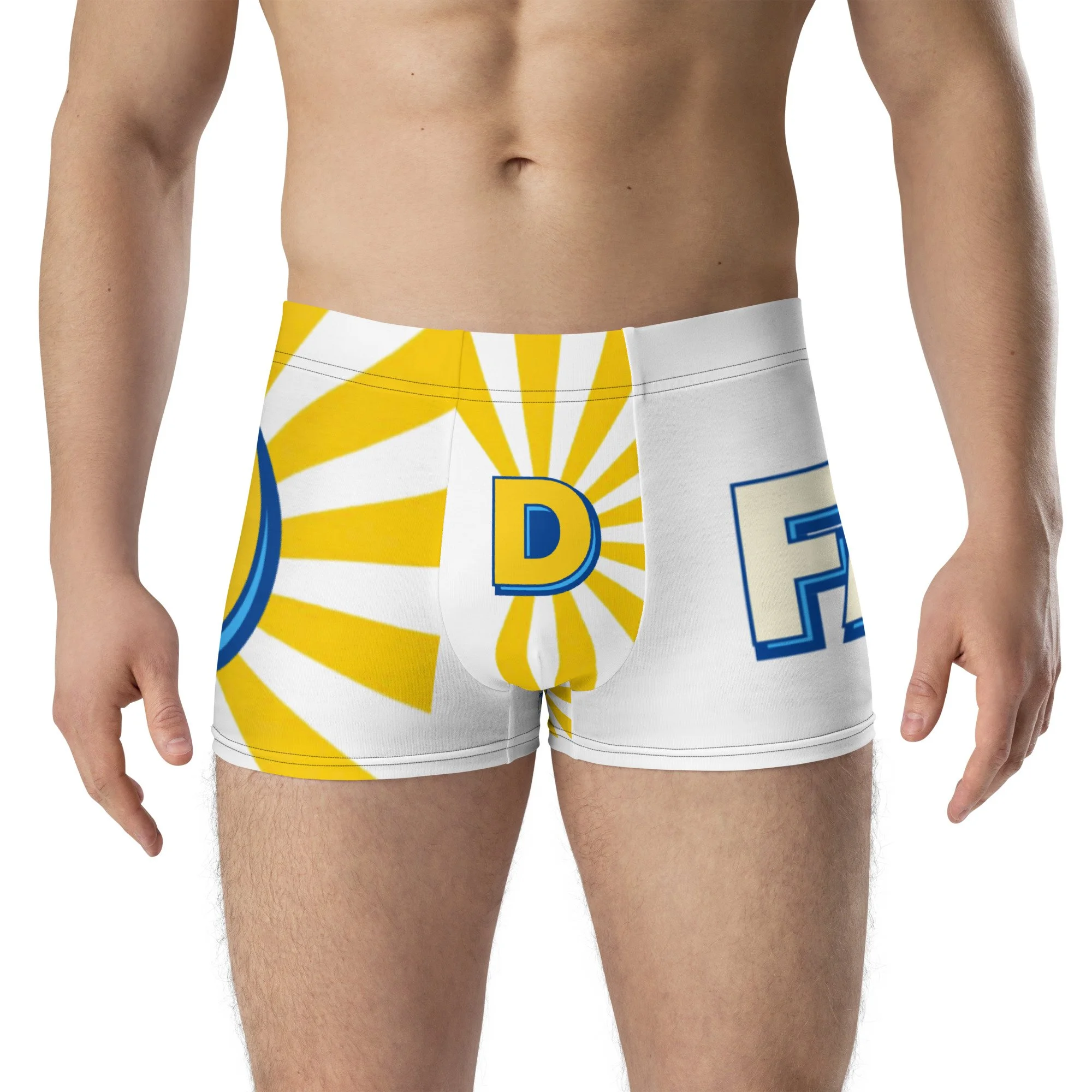 A man wearing colorful boxer shorts featuring a yellow sunburst and large blue letter 'B' connected by lines.