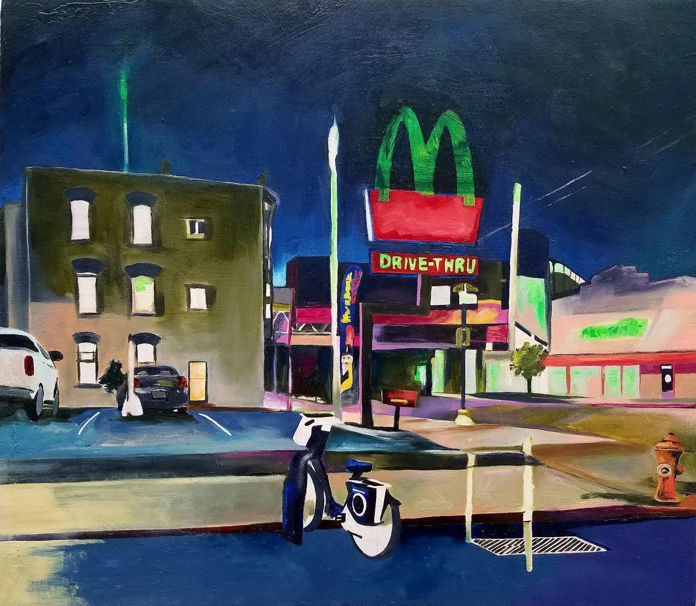 Night scene of a city street with a McDonald's sign and drive-thru, parked cars, bicycles, and a person walking near the buildings, illuminated by neon lights by contemporary New Mexico-based, multi-disciplinary artist Sarah Heyward