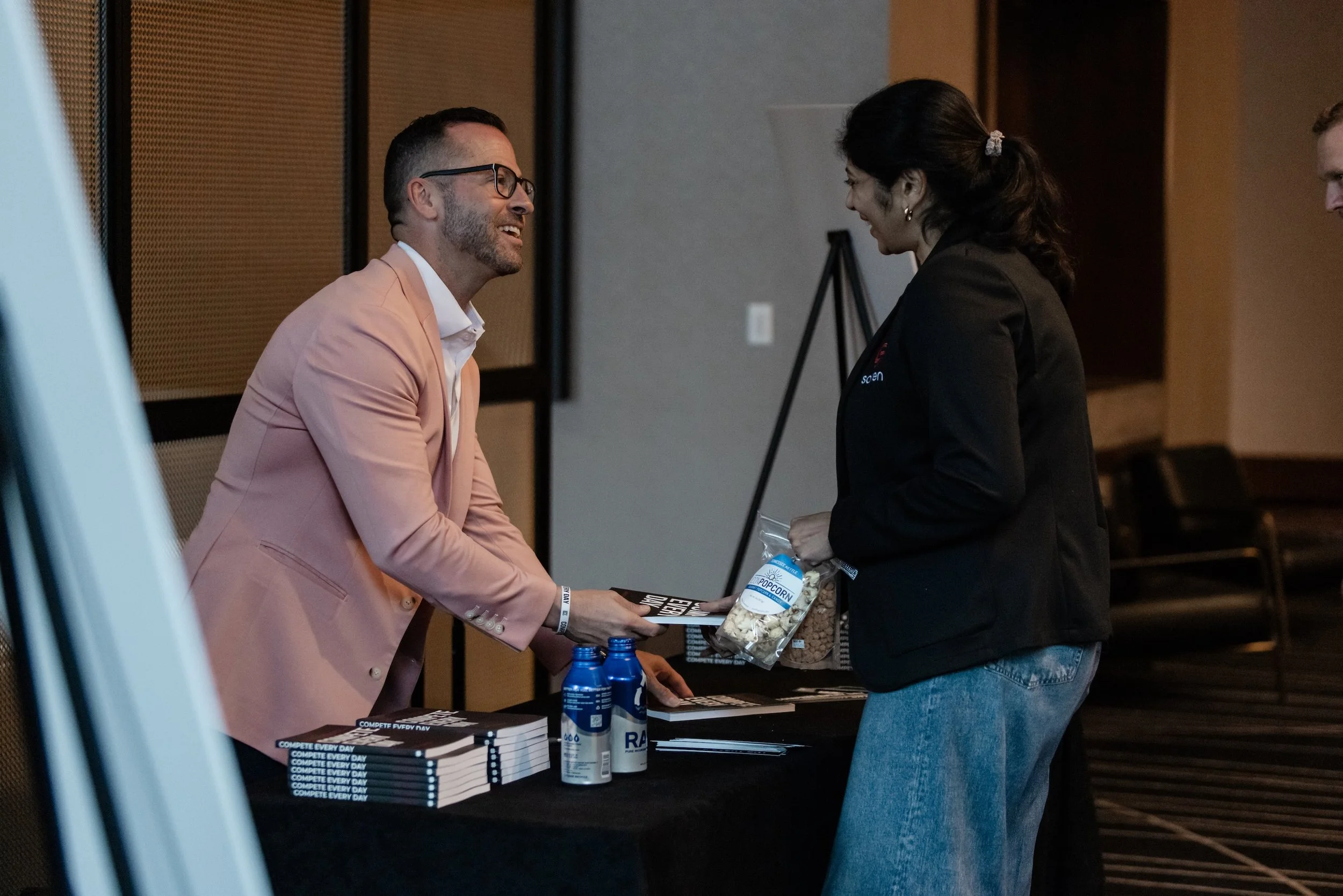 Author Jake Thompson with an audience member following his keynote