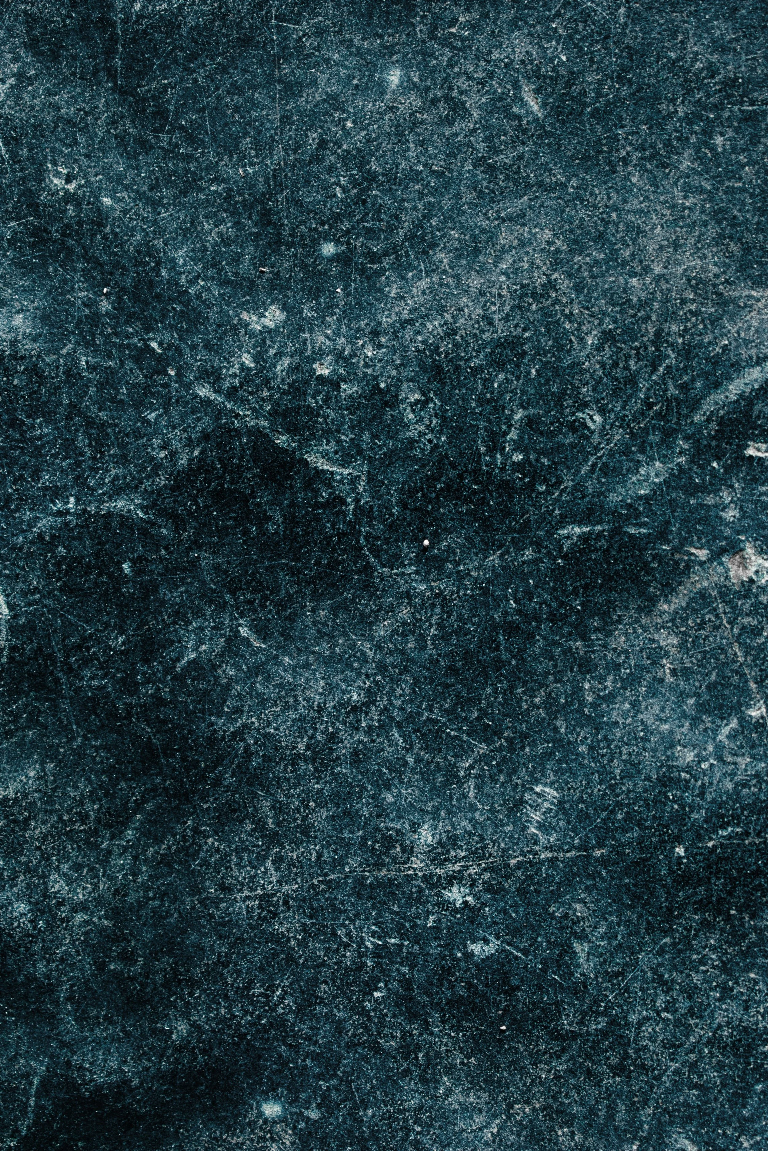 Close-up view of a textured dark surface, possibly a stone or metal material.