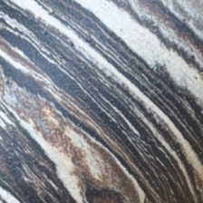 Close-up of a textured stone surface with gray, white, and brown streaks.