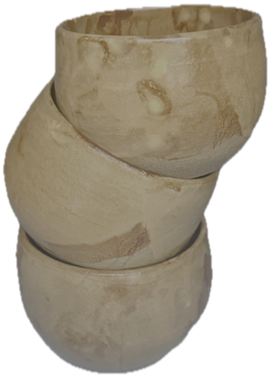 Stacked beige ceramic cups with a cracked and weathered appearance.
