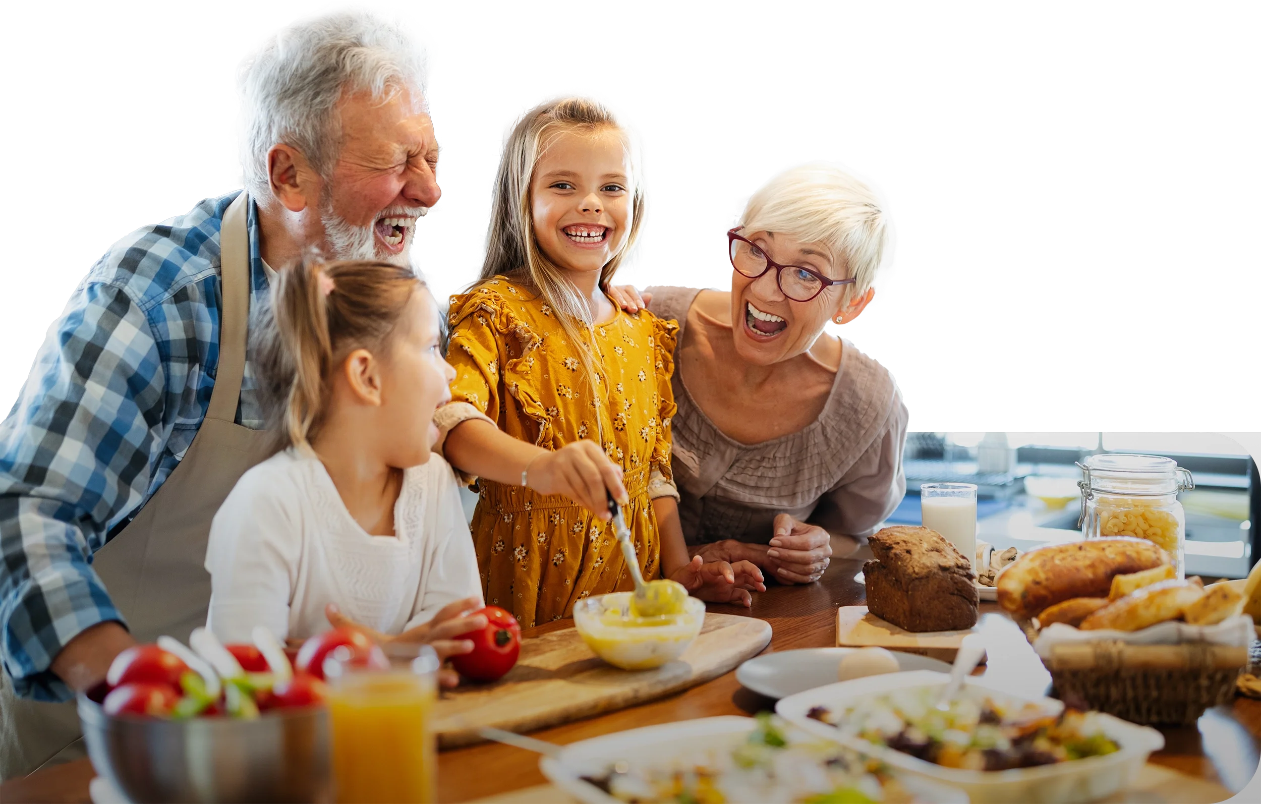 A multigenerational family of five enjoying a meal together in a bright kitchen, with food and drinks on the table.