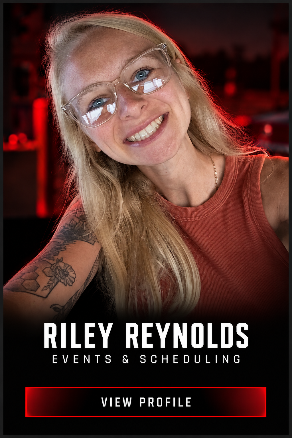 Promotional profile graphic featuring smiling blonde woman in glasses with tattooed arm, labeled Riley Reynolds Events & Scheduling, with a View Profile button.