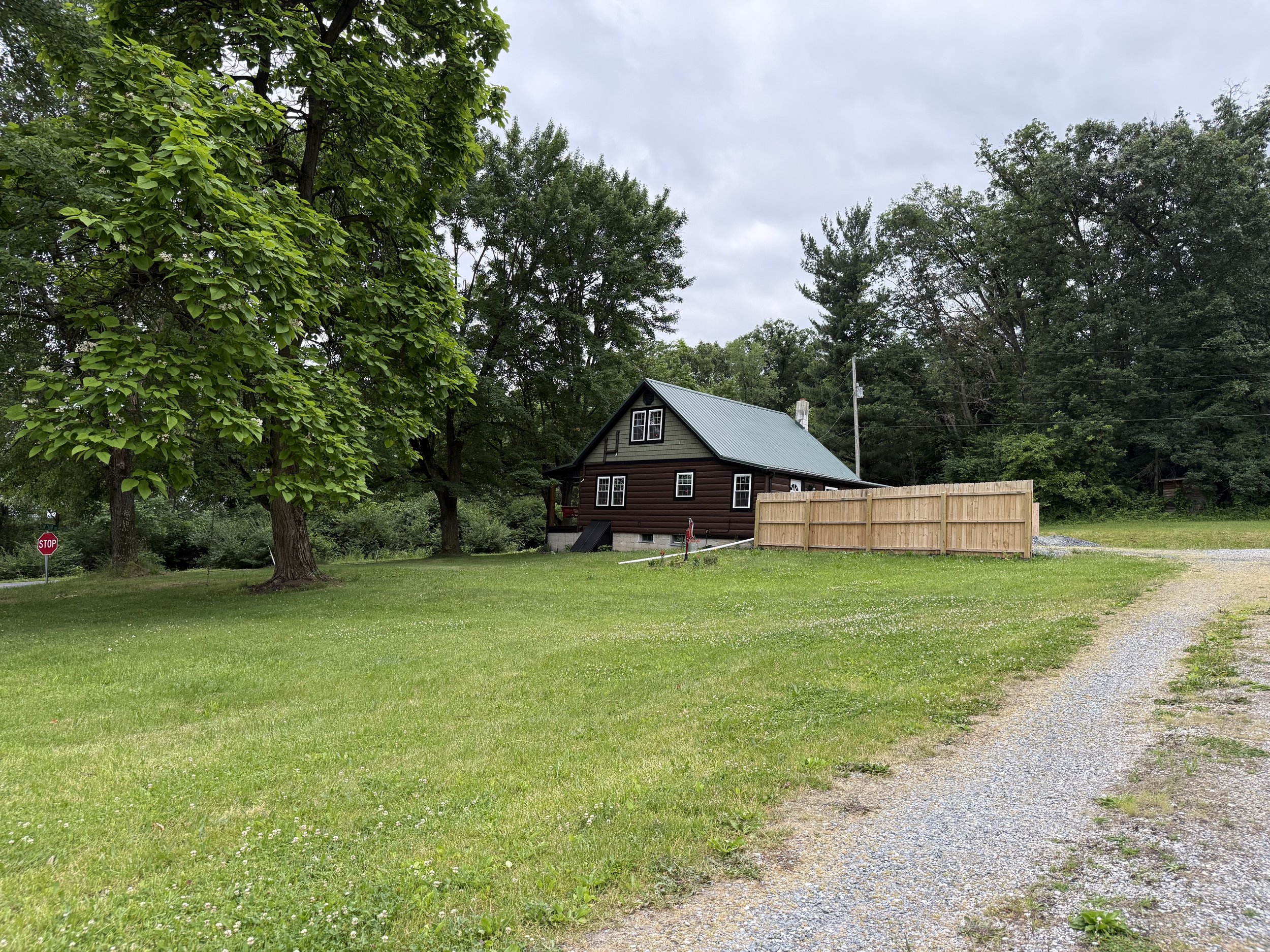 driveway leads to the back of the house and has a privacy fence to park behind