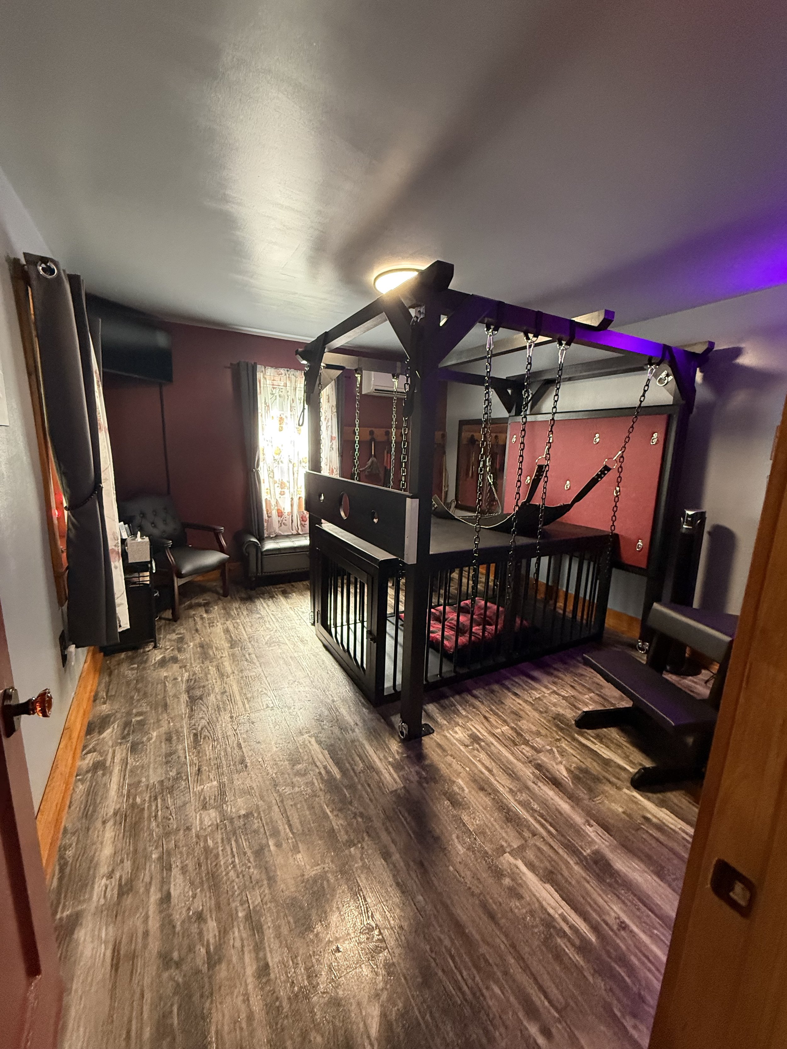 Full dungeon includes a St Andrew's cross, cage, prayer bench, spanking bench, and a swing.  There is extra floggers, paddles and blindfolds for guest to use.  