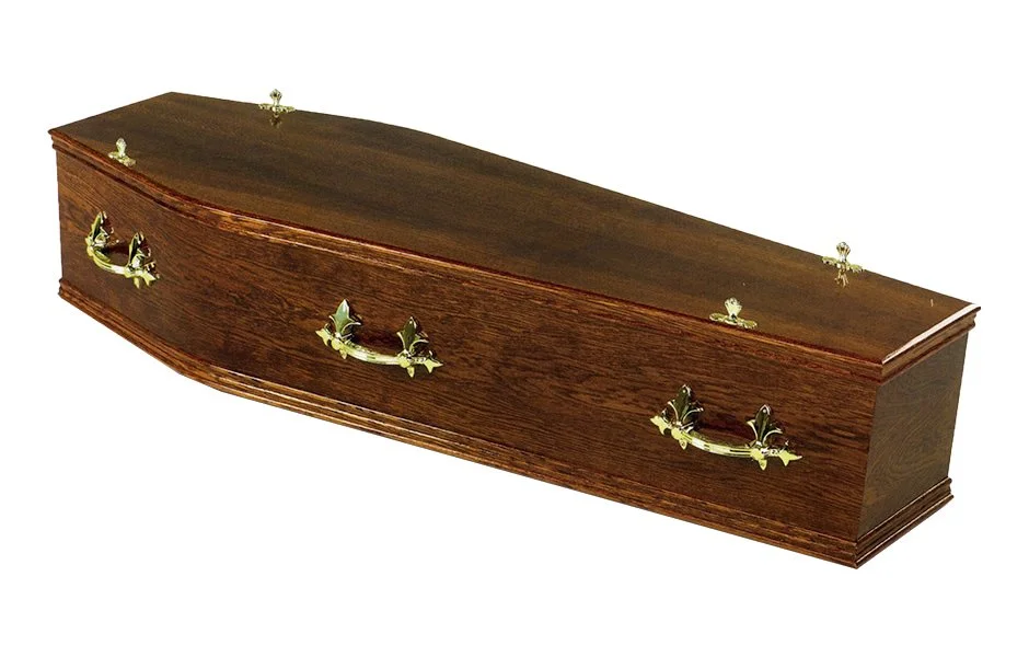 A polished wooden coffin with brass handle accents.