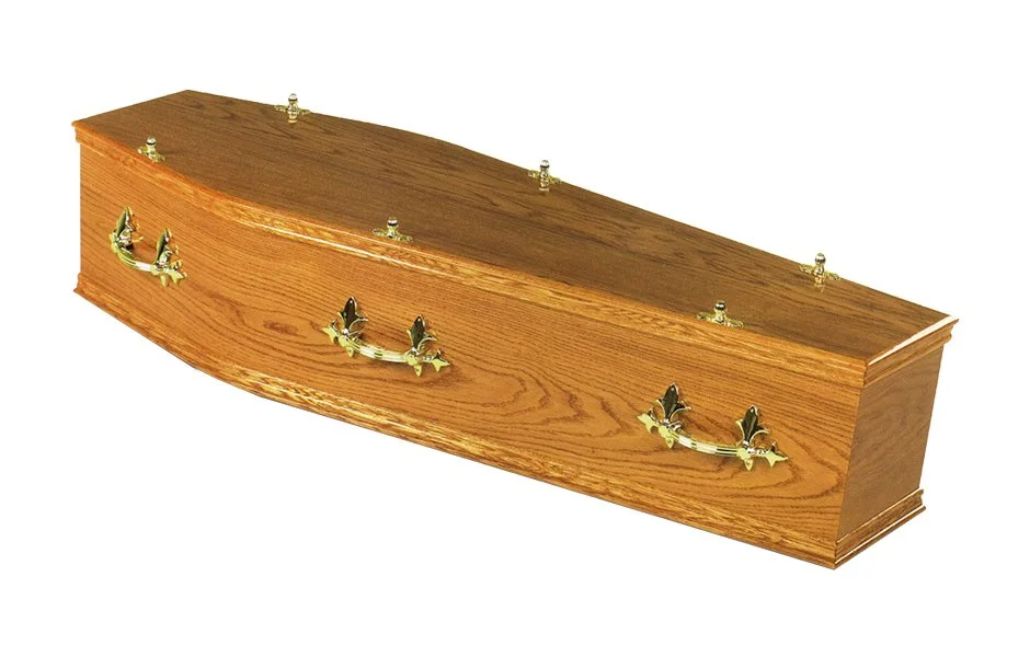 Wooden casket with brass handles and decorative hardware.