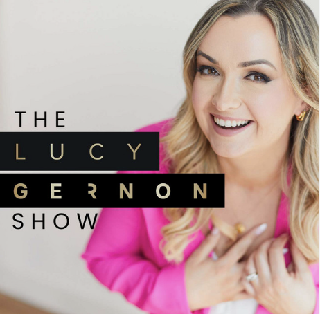 A woman smiling in a pink blazer next to a logo for The Lucy Gernon Show.
