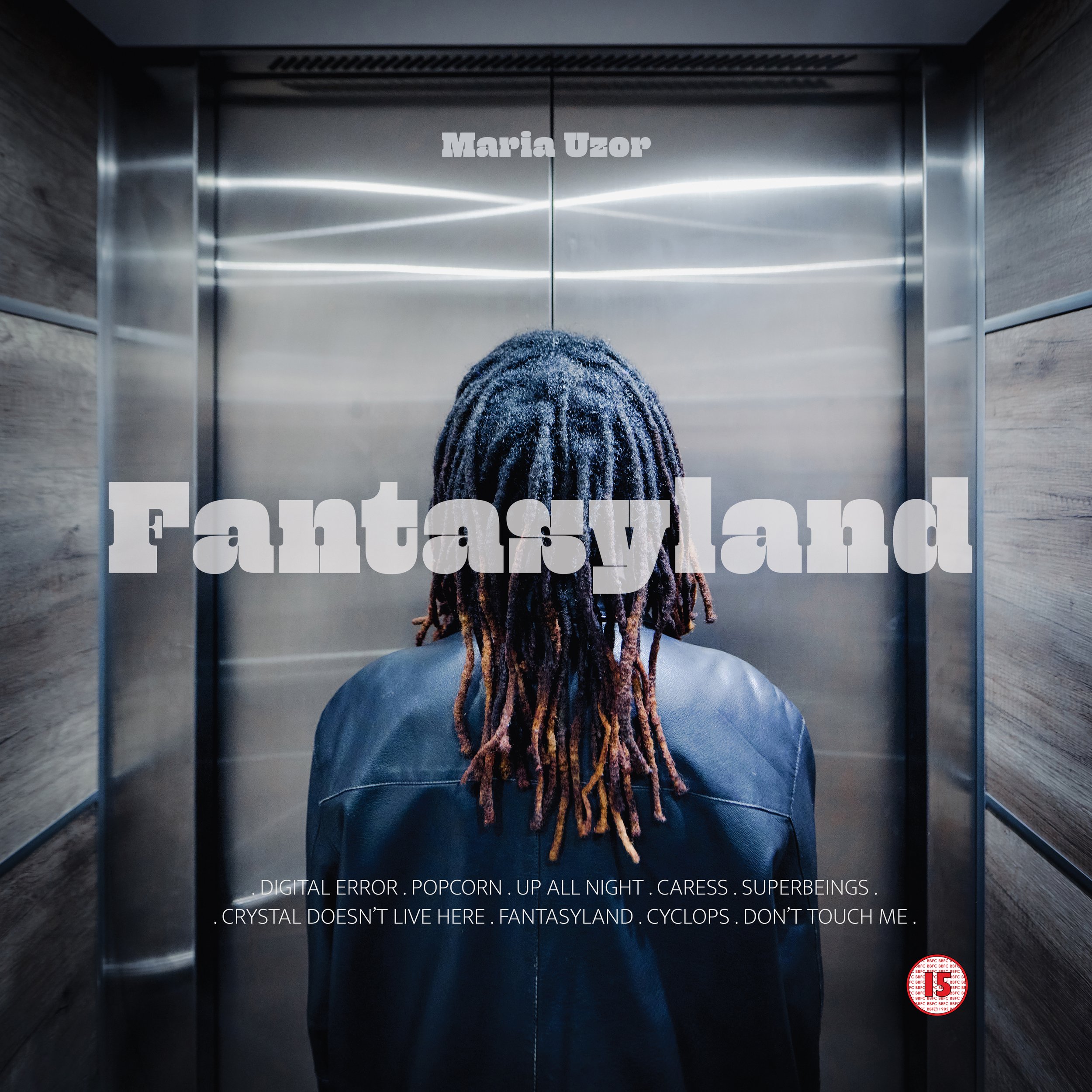 View from the top of an elevator looking down at a person's head with dreadlocks inside the elevator. The elevator has metallic doors and appears to be in a modern building with wood paneling. Text overlays the image, including the name "Maria Uzor" at the top center and various phrases at the bottom such as "DIGITAL ERROR," "POP CORN," "UP ALL NIGHT," "CARESS," "SUPERBEINGS," "CRYSTAL," "FANTASYLAND," "CYCLOPS," and "DON'T TOUCH ME."