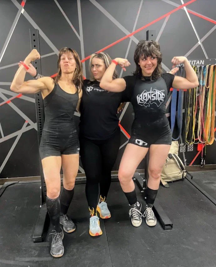 Me, my coach, and my daughter after a powerlifting meet
