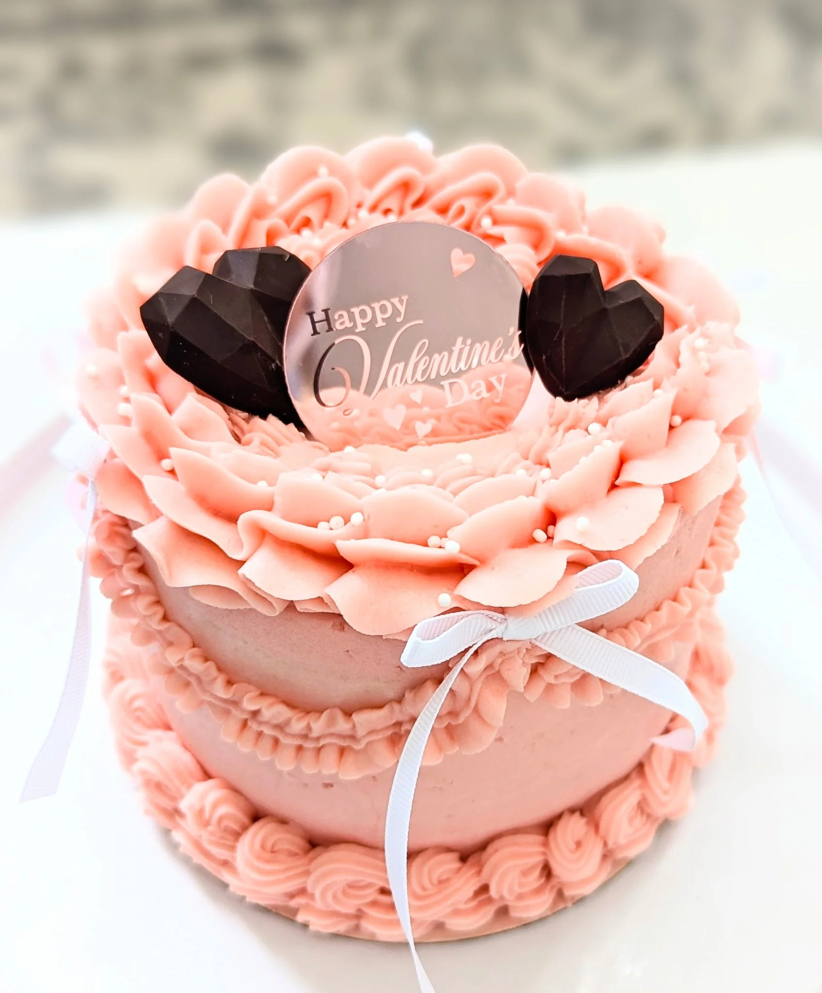 Red Happy Valentines day cake with 2 chocolate hearts on top