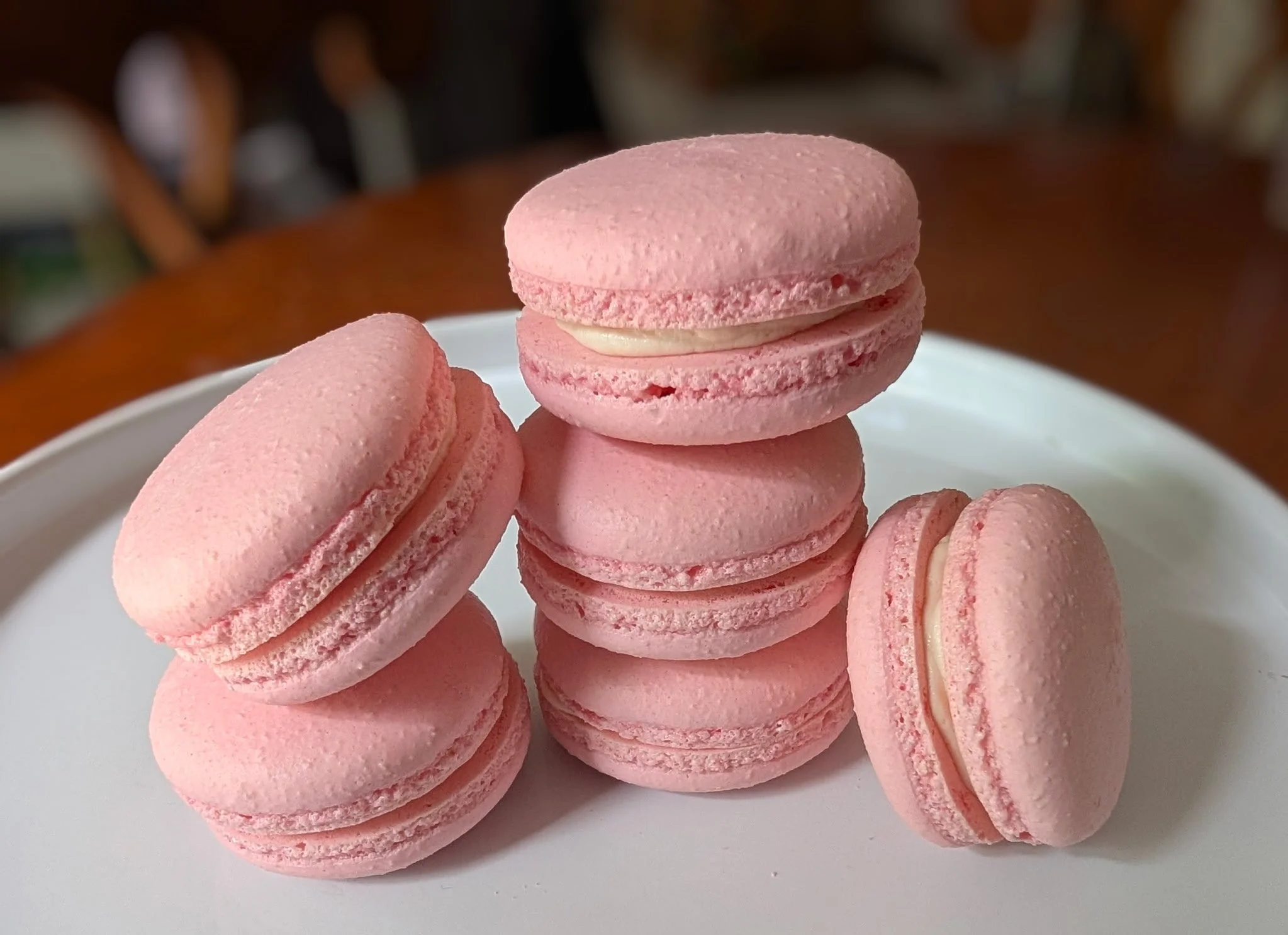 Pink Macarons stacked onto a plate