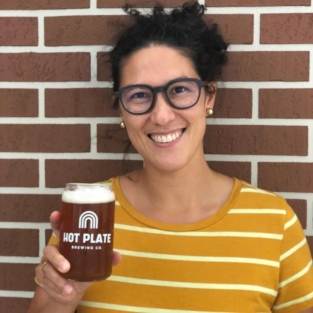 girl holding hot plate brewery logo glass