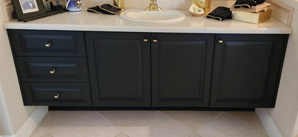 Refinished bathroom cabinets in black.