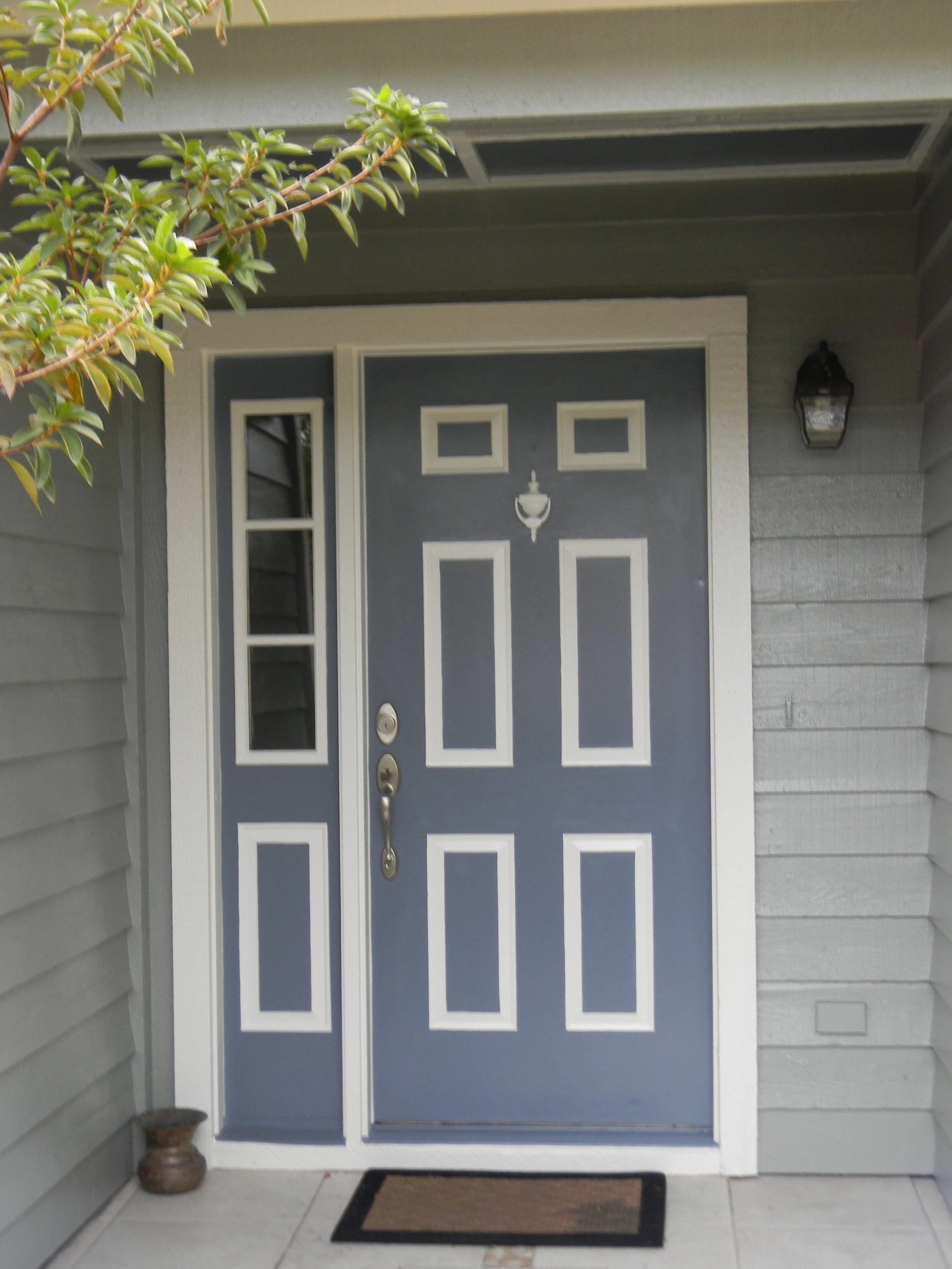 Repainted front door and entry ceiling with white accents.