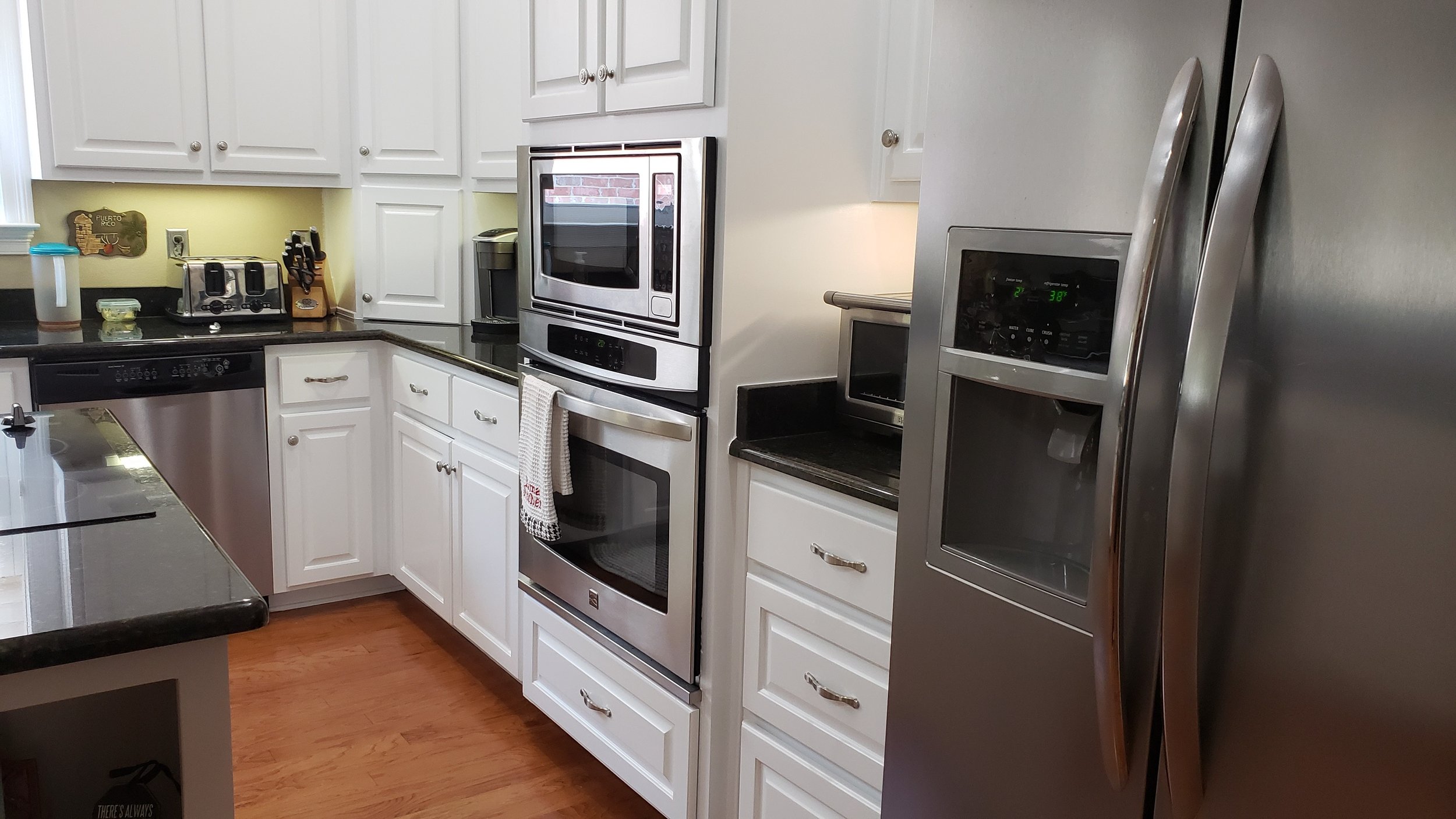 Refinished cabinets in kitchen and kitchen island.