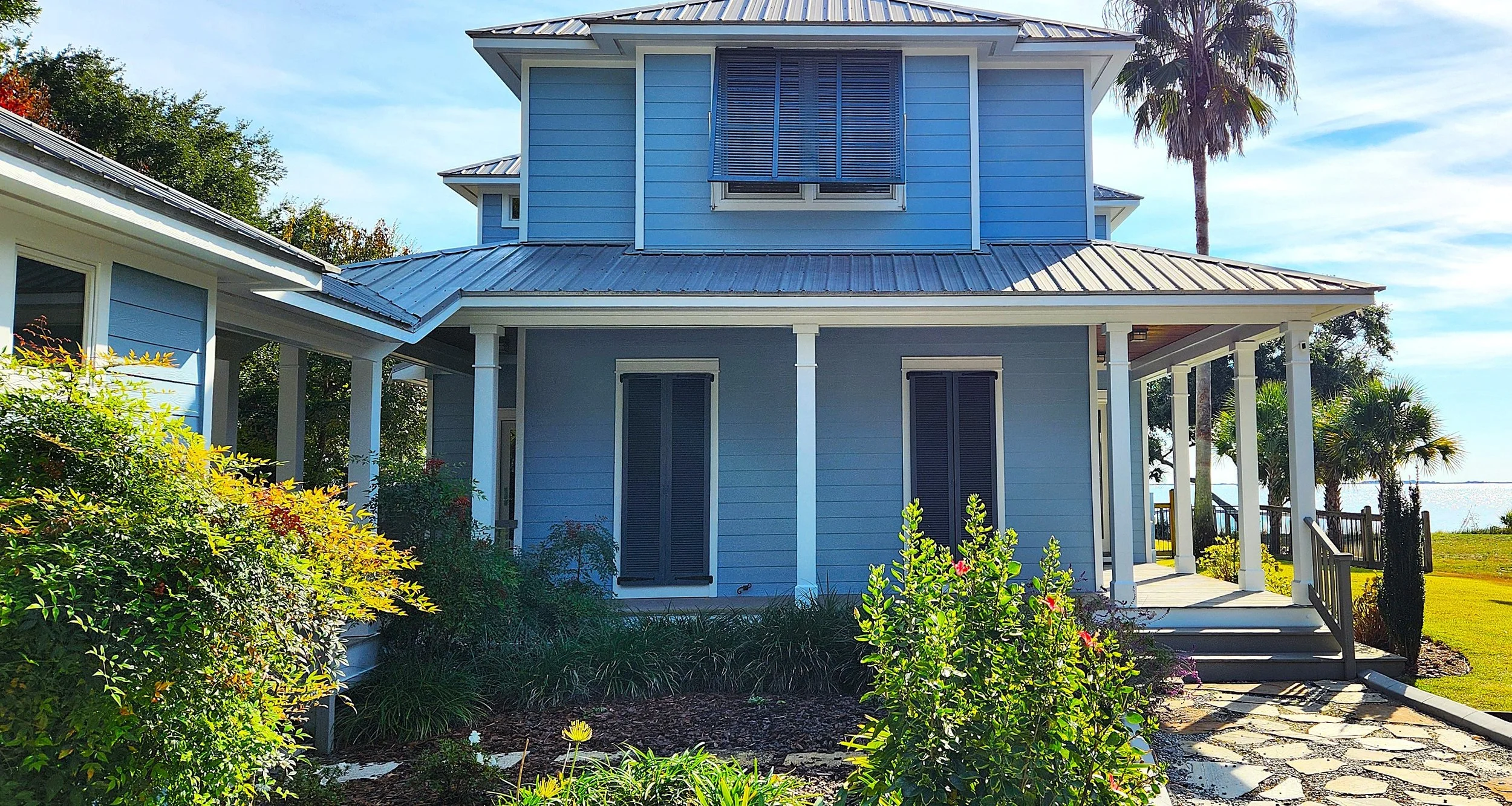 Repainted exterior home, shutters, walkway, garage, and restained exterior ceilings - AFTER.