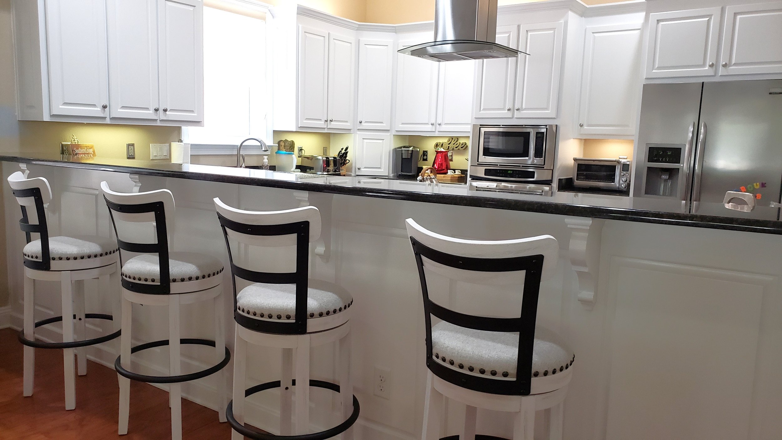 Kitchen cabinet and kitchen island refinished cabinets.