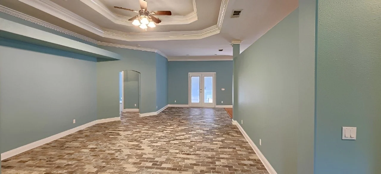 Repainted interior with baseboards, crown molding and tray ceilings.