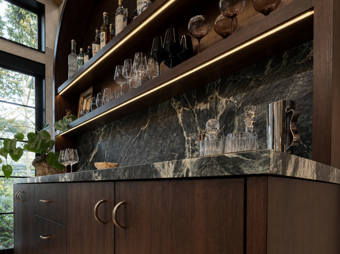 A picture of a custom built-in bar counter made out of walnut with a green marble counter top.