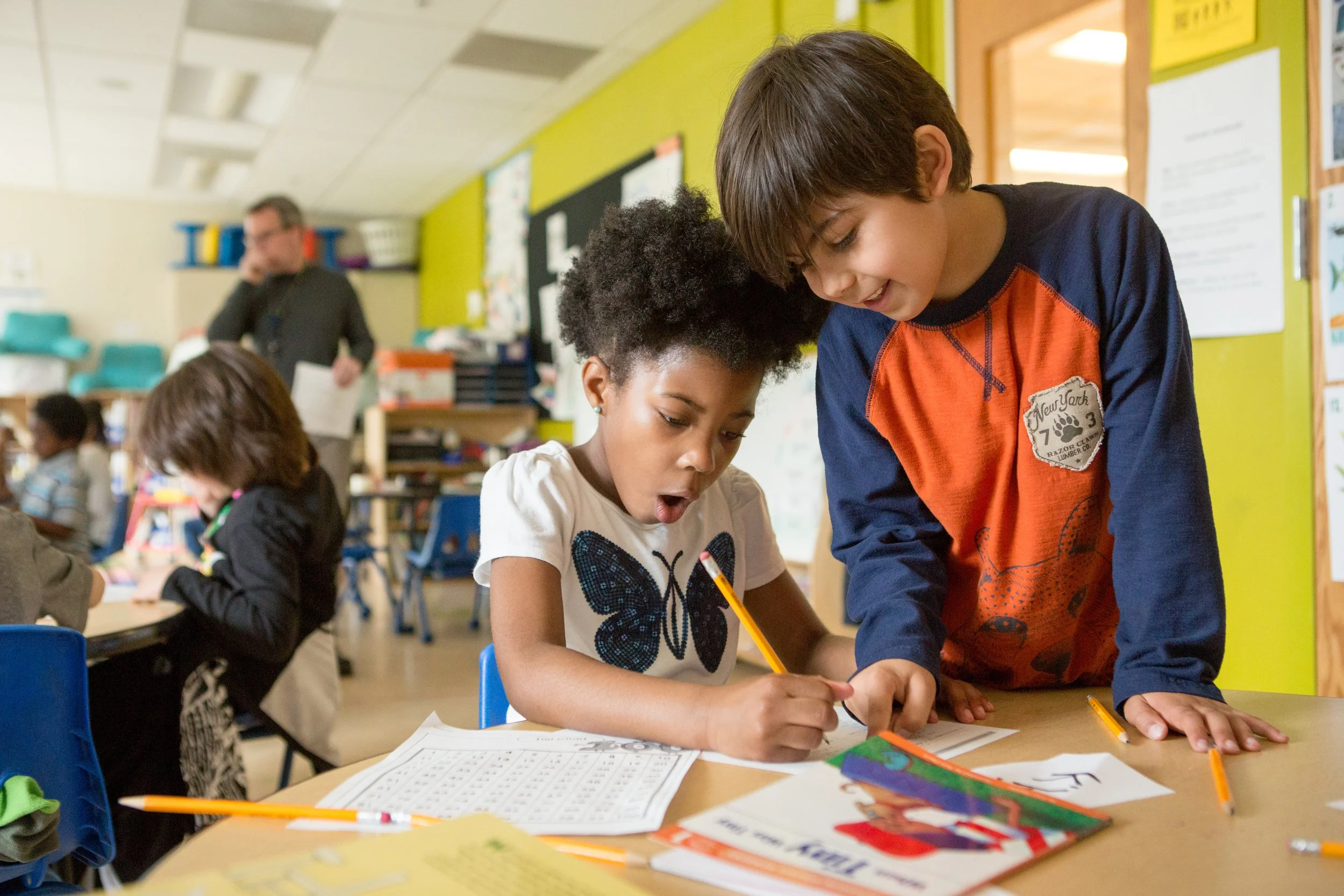 Young girl and boy exciting about writing together