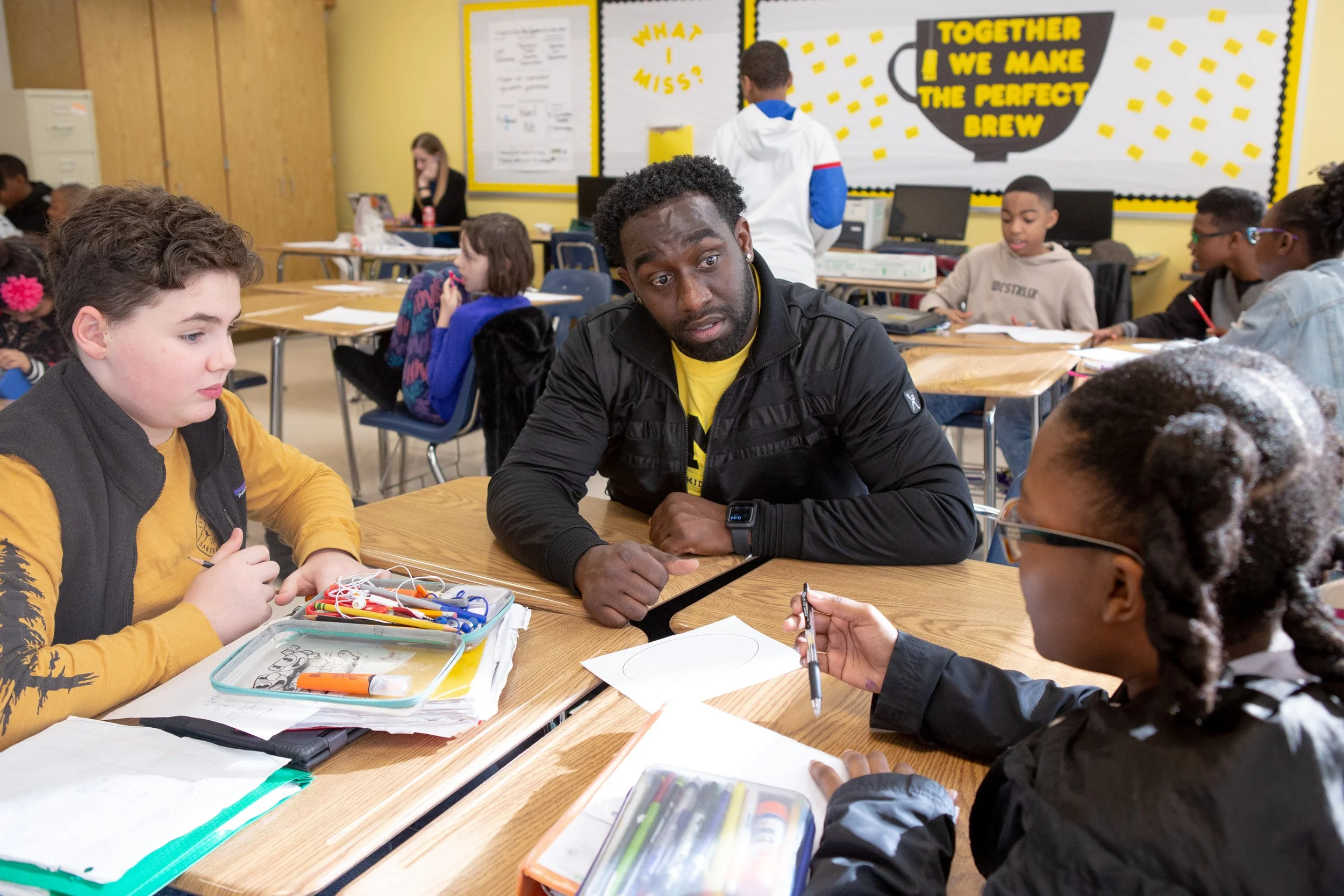 Teacher working with students in a classroom