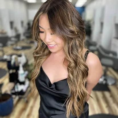 Young woman with long wavy hair in a salon