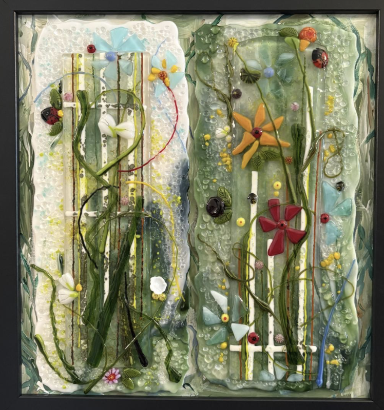 Camille Toppo Designs - Colorful glass art with flowers, butterflies, ladybugs, and abstract patterns inside a black frame.
