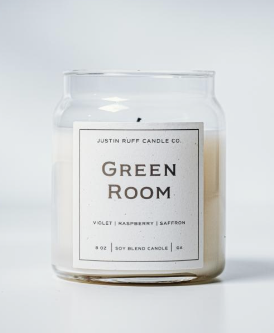Justin Ruff Candle Co - A white soy blend candle in a clear glass jar with a minimalist label that reads "Green Room" by Justin Ruff Candle Co., with scent notes of violet, raspberry, and saffron.