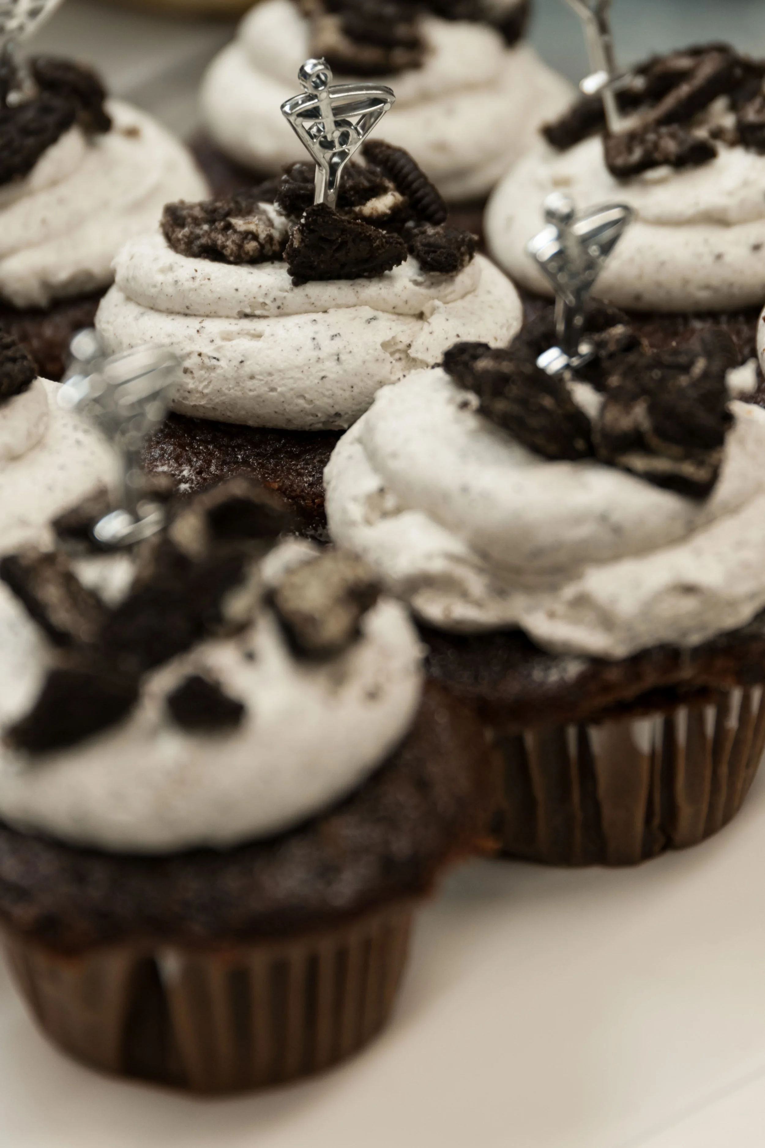Chocolate cupcakes topped with cookies and cream frosting and Oreo cookies with superhero toppers.