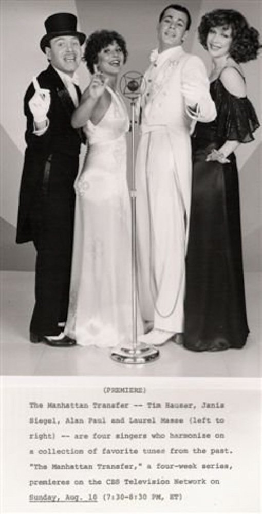 Black-and-white photo of four singers from the TV series "The Manhattan Transfer" standing together in vintage attire, smiling and posing for the camera.