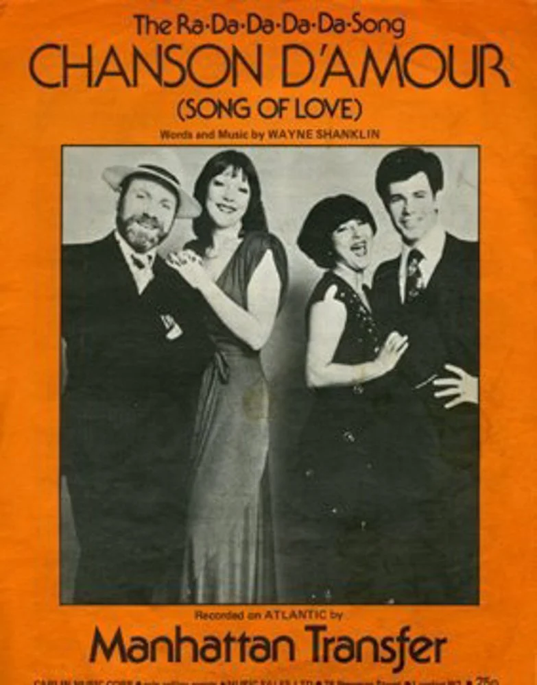 Cover of a song sheet titled "Chanson D'amour (Song of Love)" with a black-and-white photo of four smiling people dressed in vintage clothing, set against an orange background.