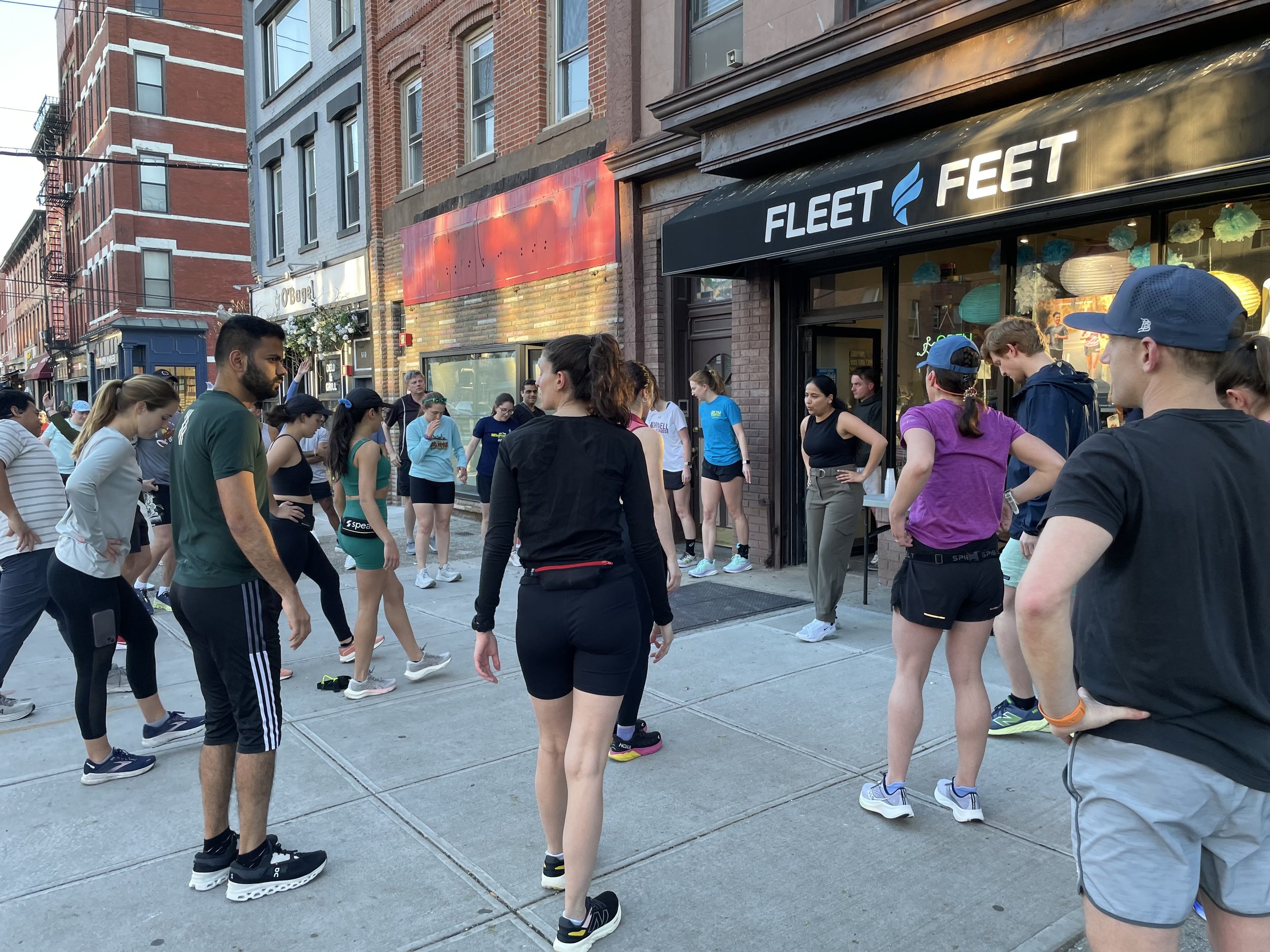 Akanksha Rathod, Founder of Nee's Physical Therapy Hoboken giving Fleet Feet runners a stretching session pre-run