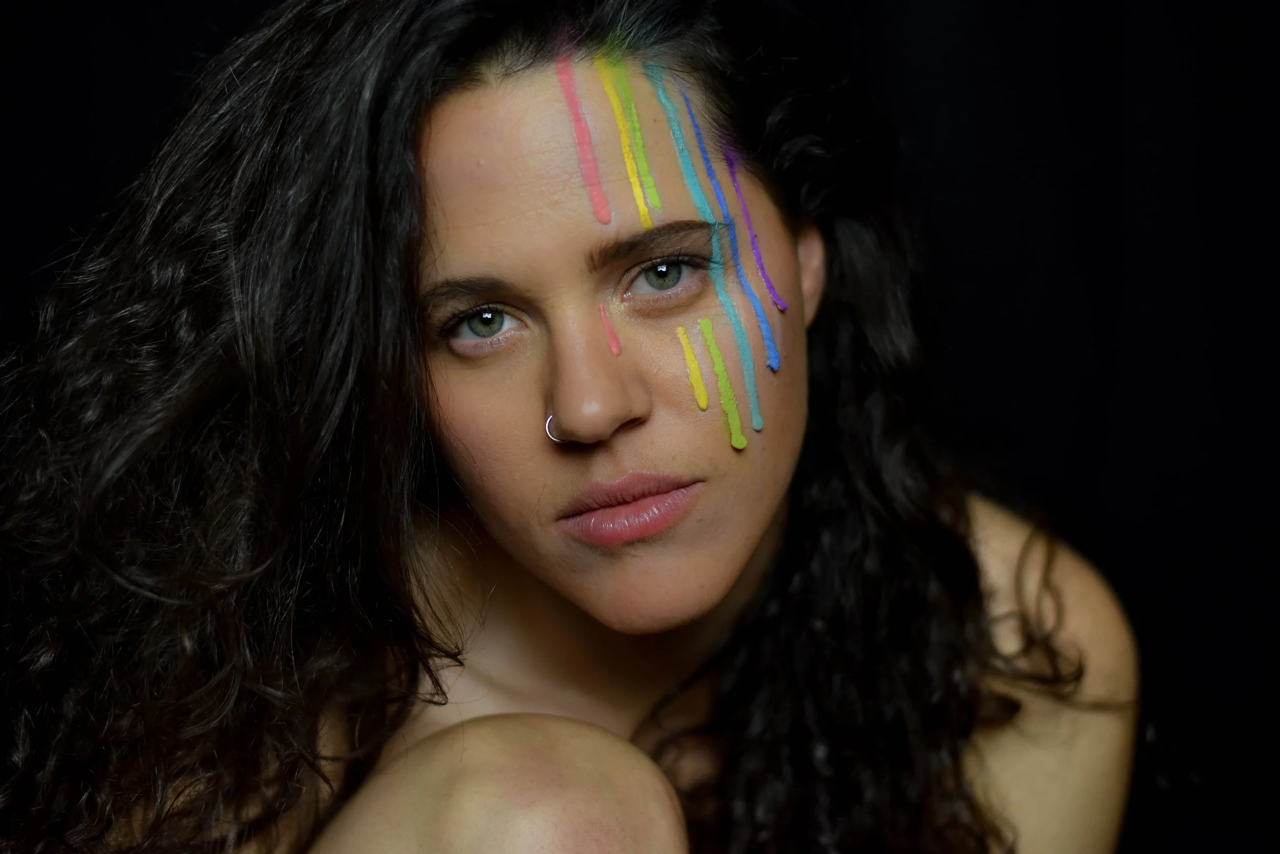 A colorful portrait celebrating LGBTQ+ visibility and community. As the founder of Wild Queer Free, Rachael is passionate about documenting queer stories with authenticity and care.