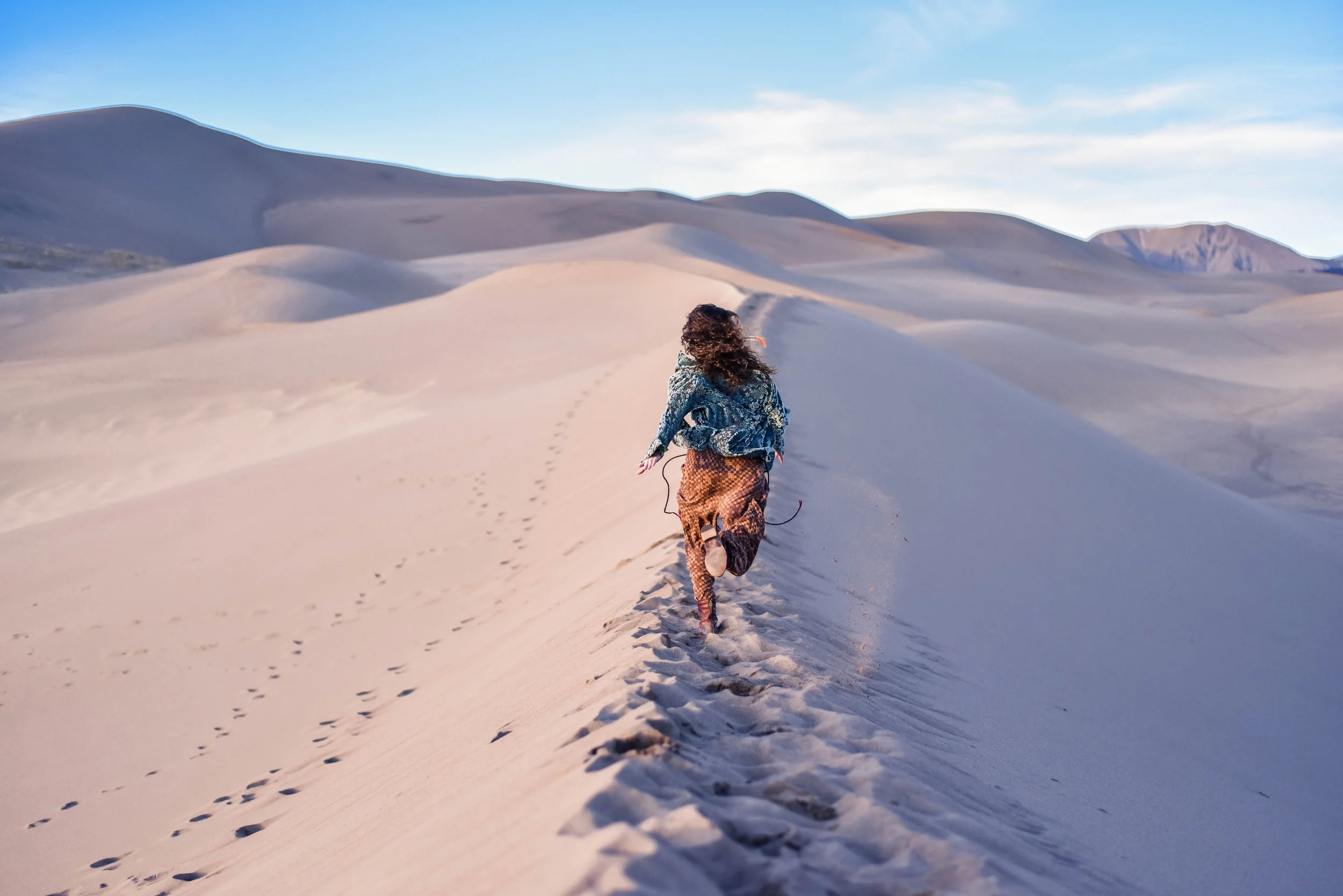 Exploring a national park with camera gear and hiking boots. Wild Queer Free was built for people who love adventure, connection, and authentic experiences. Rachael on a road trip through the mountains searching for new adventures and photography loc