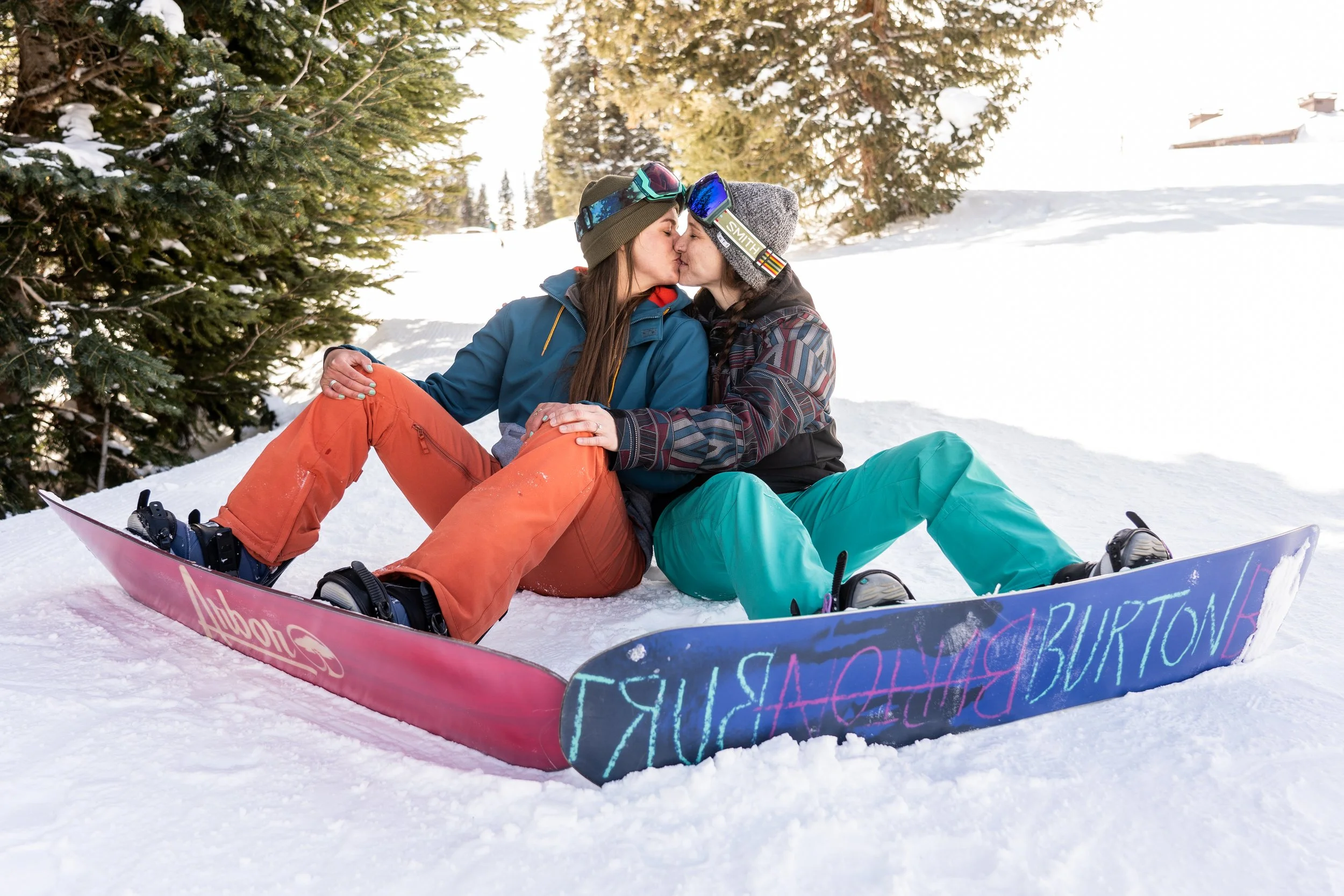 A snowboard engagement proposal is captured in the middle of a Colorado mountain adventure. The couple shares a joyful reaction immediately after the moment. This work reflects a Colorado elopement photography brand specializing in Rocky Mountain and