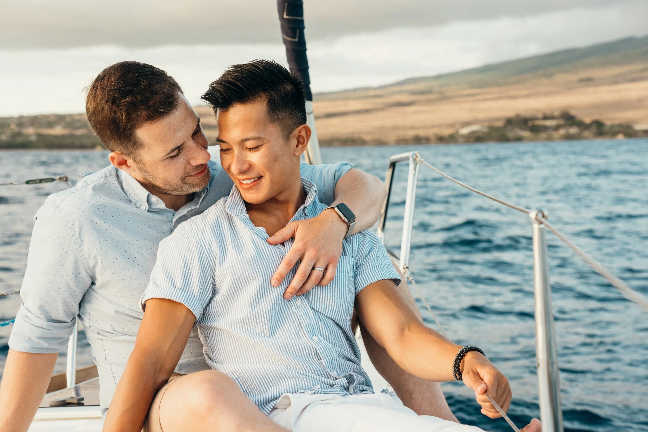 This lgbtq+ engagement session shows a queer couple on a sailboat during a romantic proposal moment. The environment is minimal and cinematic with open water. The photographer works across Colorado, including Denver, Colorado Springs, and Rocky Mount