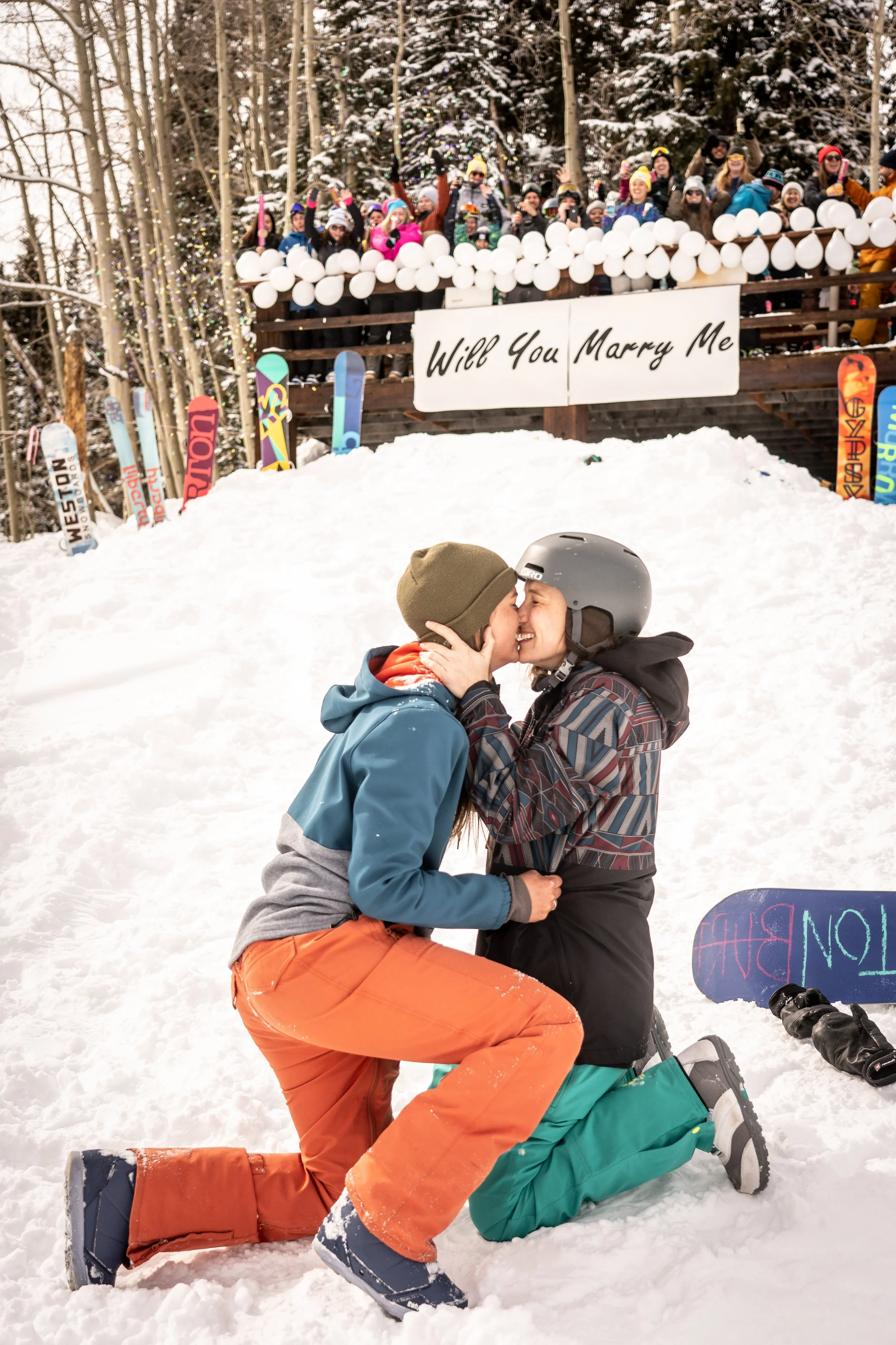 This engagement session captures a snowboard proposal in a high alpine Colorado mountain setting. The couple shares an emotional moment surrounded by expansive Rocky Mountain terrain and fresh snow. The work reflects a Colorado-based elopement photog
