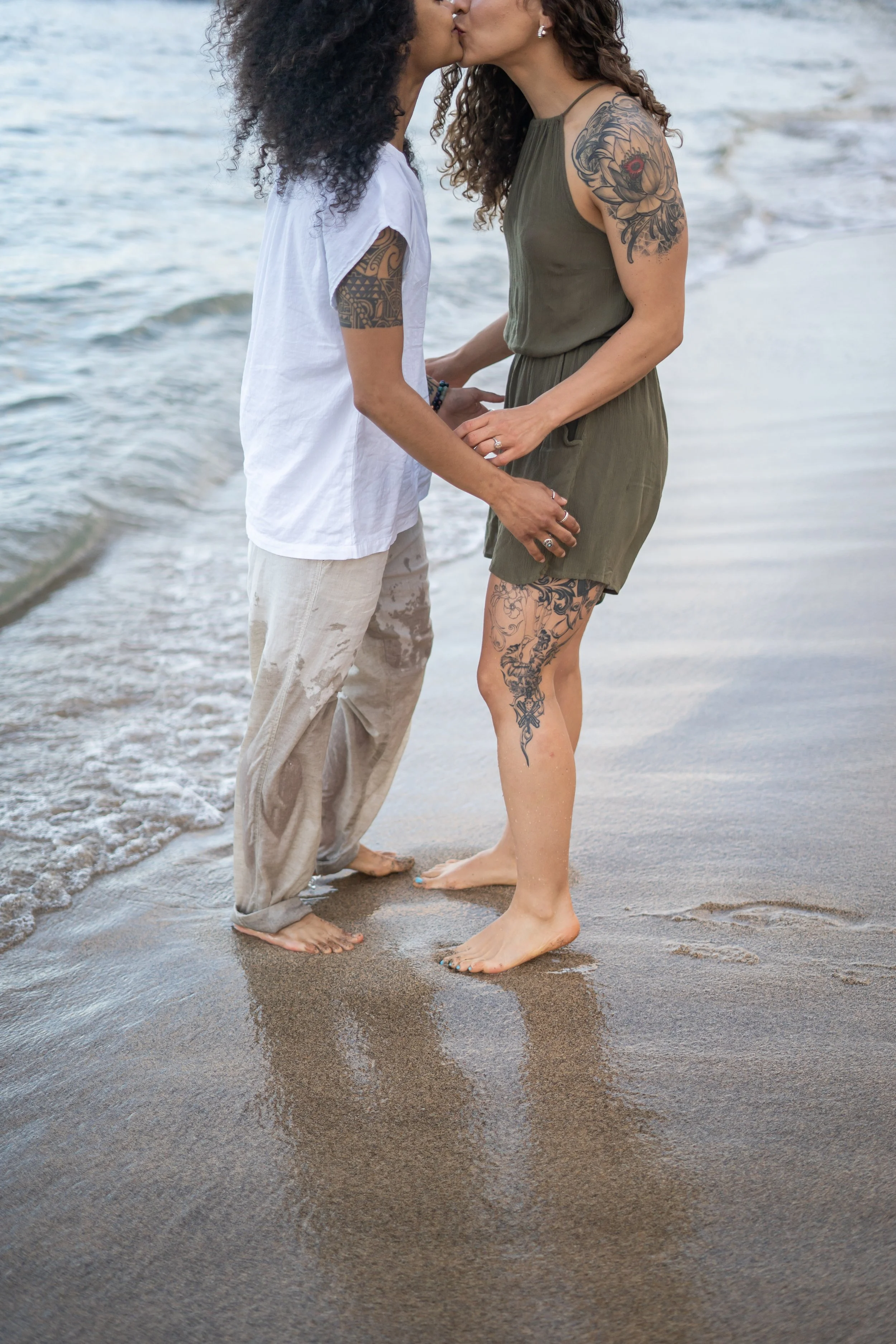 This queer engagement-style moment captures a same-sex couple in a Colorado mountain landscape with expansive views. The couple shares a natural emotional connection in the open environment. The photographer is based in Colorado and specializes in ga