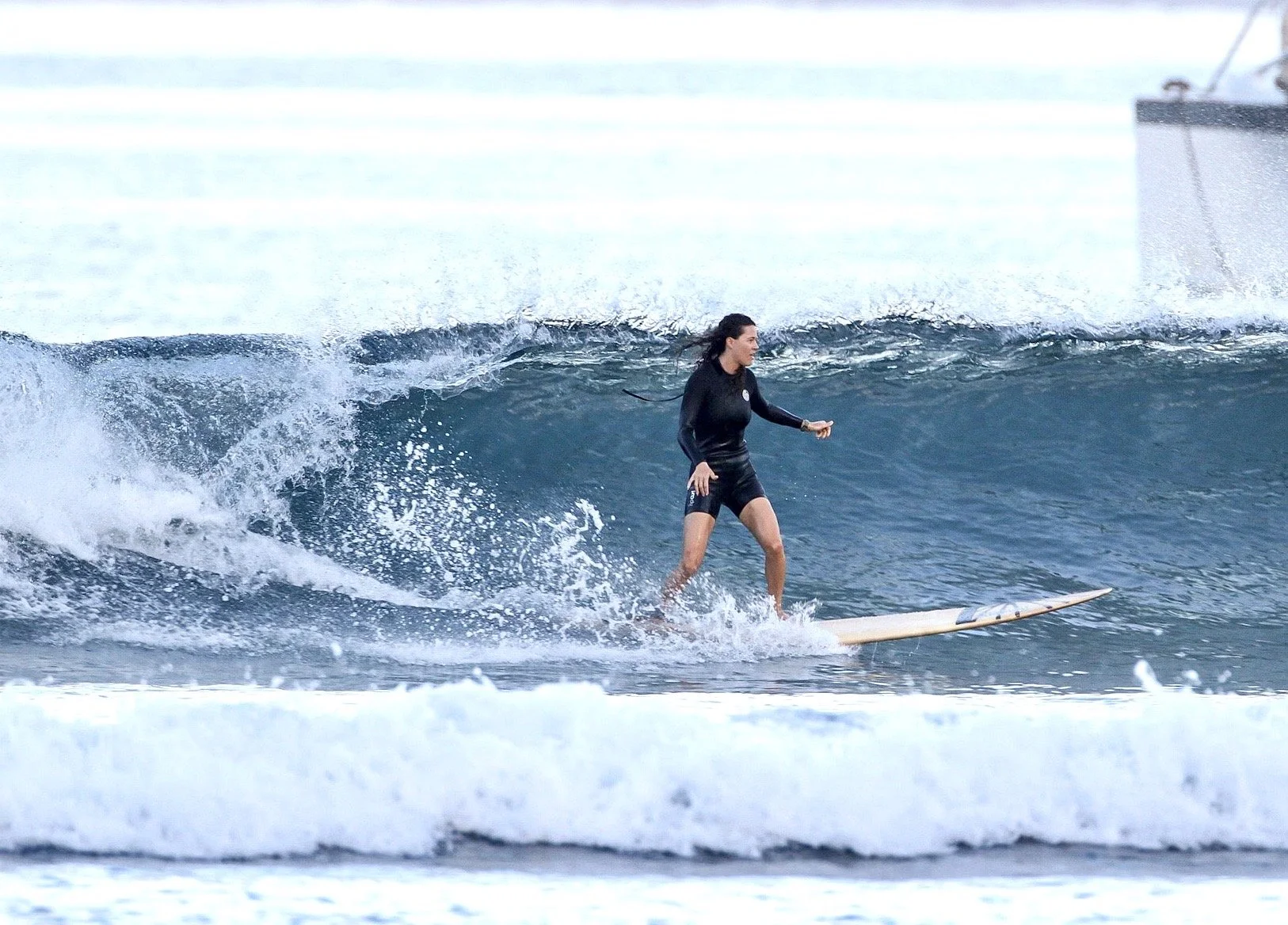 Portrait of award-winning photographer and storyteller Rachael Zimmerman. Her work blends documentary photography, LGBTQ+ community storytelling, adventure, and authentic connection. Surfing on Maui. 