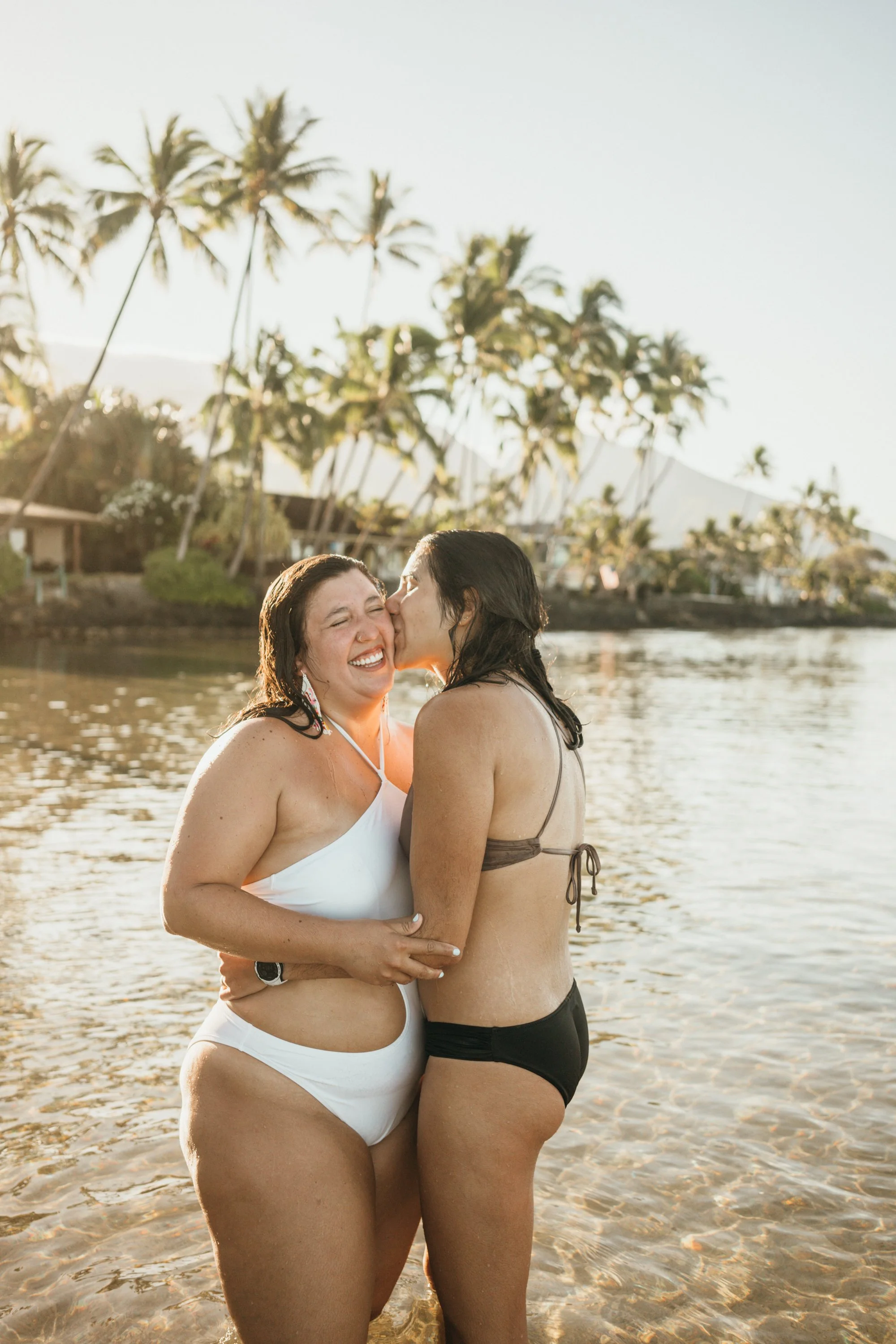 A romantic engagement unfolds at sunrise on a beach with warm coastal light. The couple stands close together after the proposal moment, taking in the surroundings. The imagery focuses on authenticity and emotional presence. While this is a destinati
