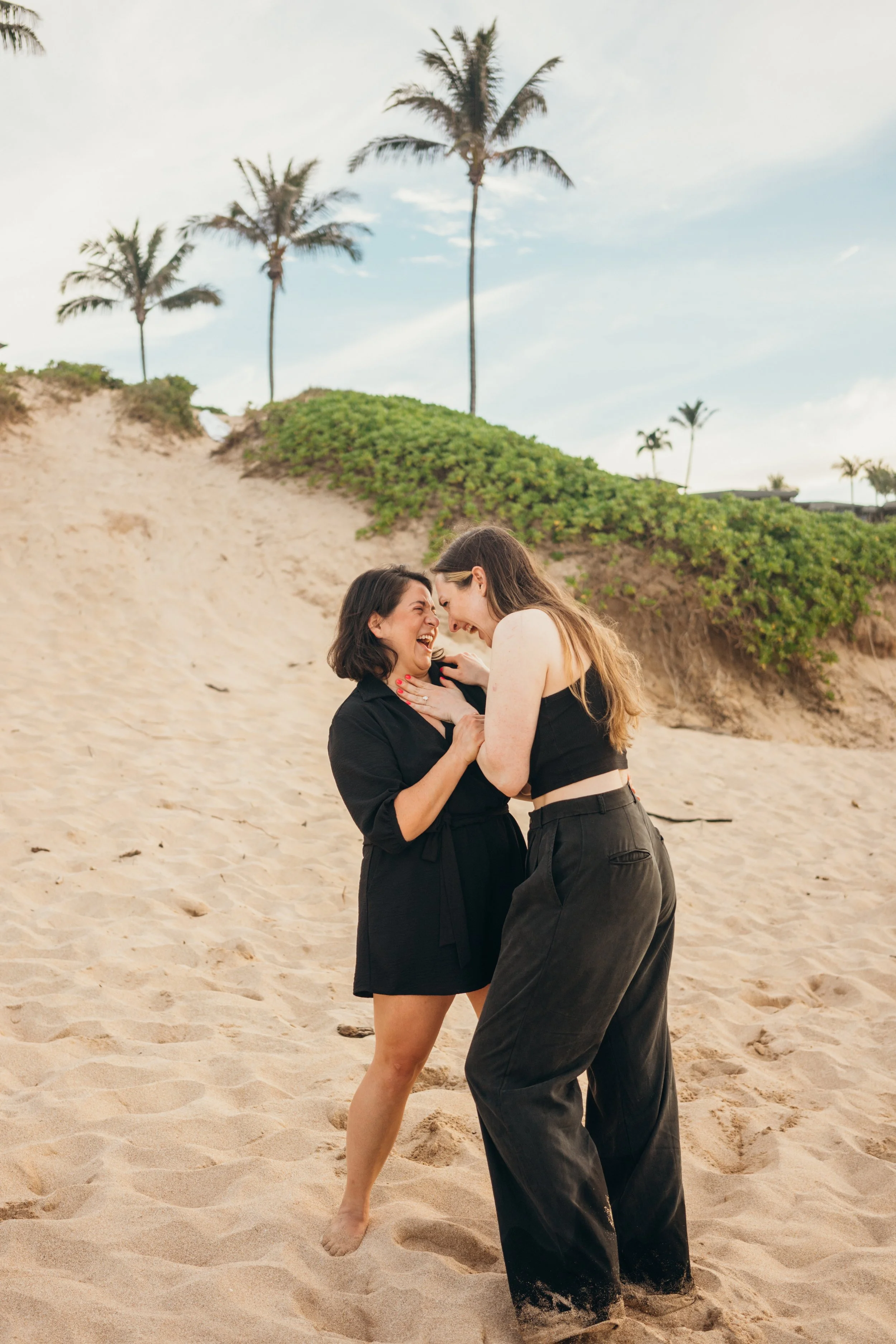 A same-sex queer engagement-style moment is captured in downtown Denver with architectural framing. The couple shares a natural emotional connection while moving through the city. This Colorado-based photographer focuses on gay and lesbian elopements