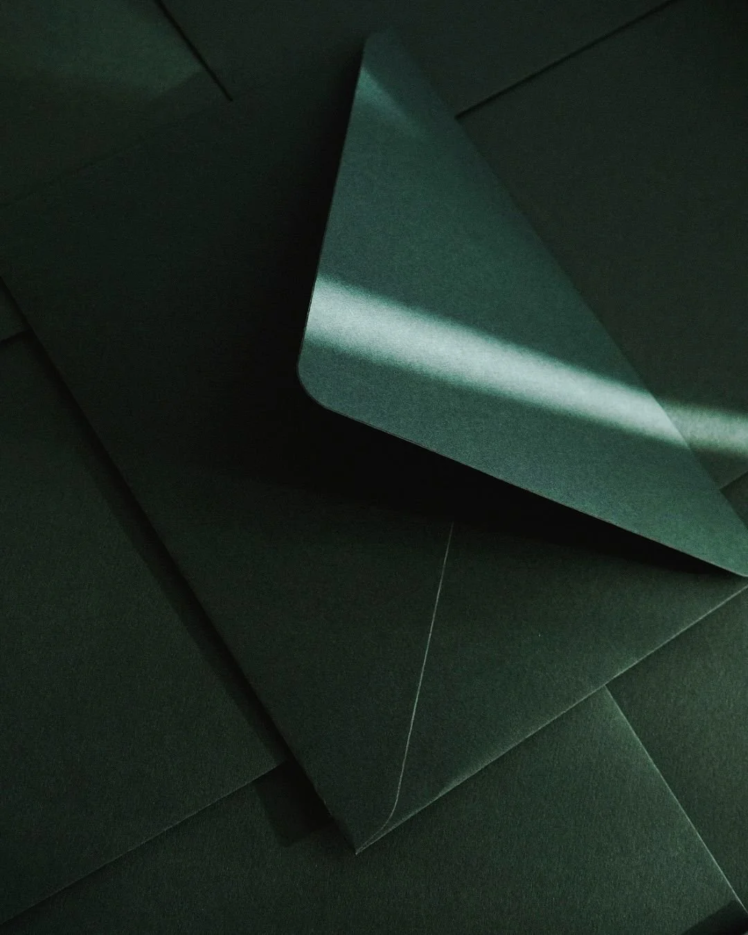 Close-up of dark green envelopes.